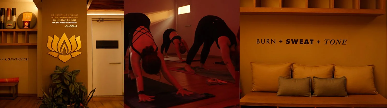 Grupo de personas haciendo estiramientos en un estudio de yoga o fitness con paredes decoradas con frases motivacionales y símbolos de yoga.