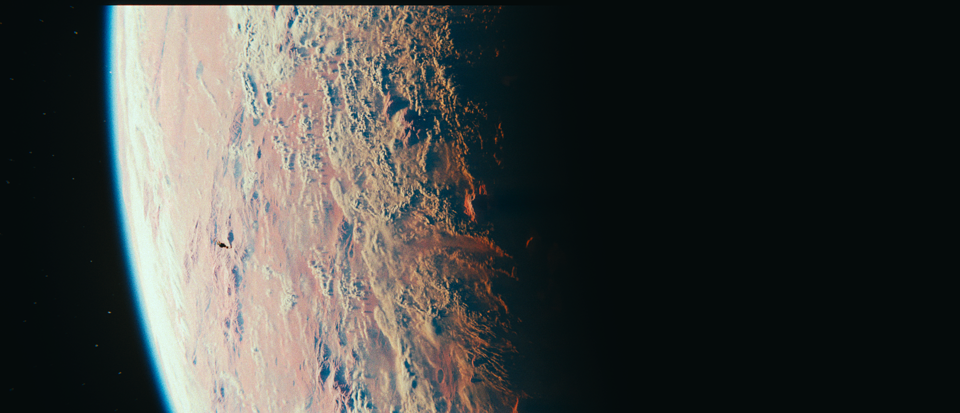 Close-up view of Mars from space, showing its cratered reddish surface, atmosphere, and dark horizon.
