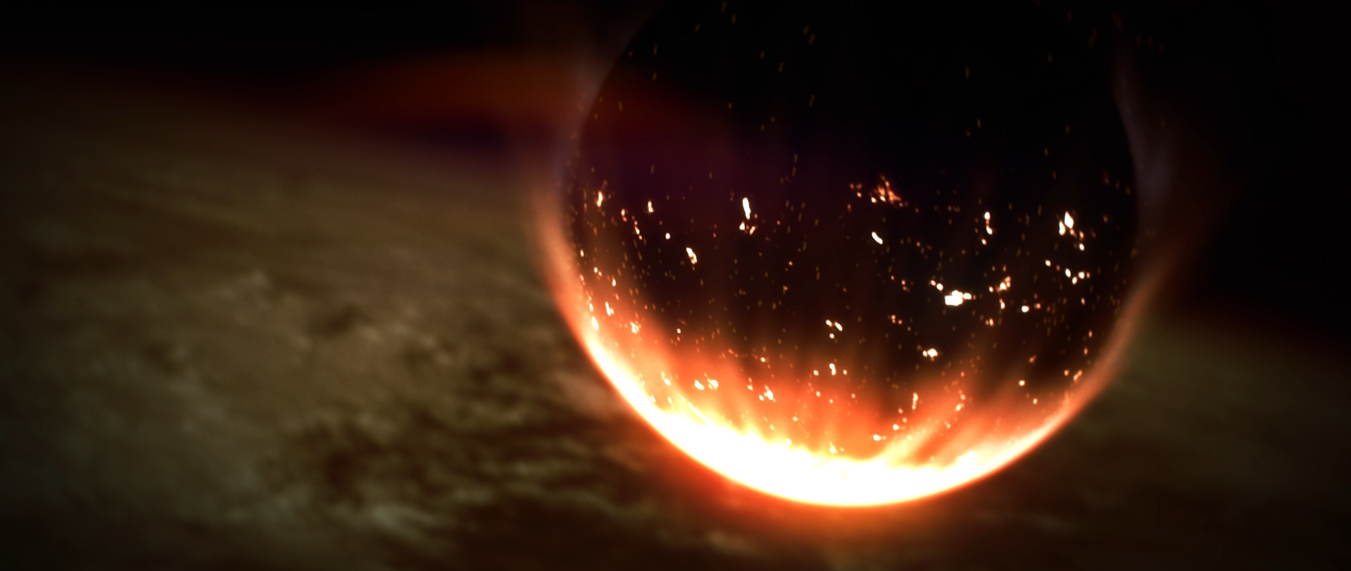 Glowing fireball with flying sparks over a dark, smoky surface