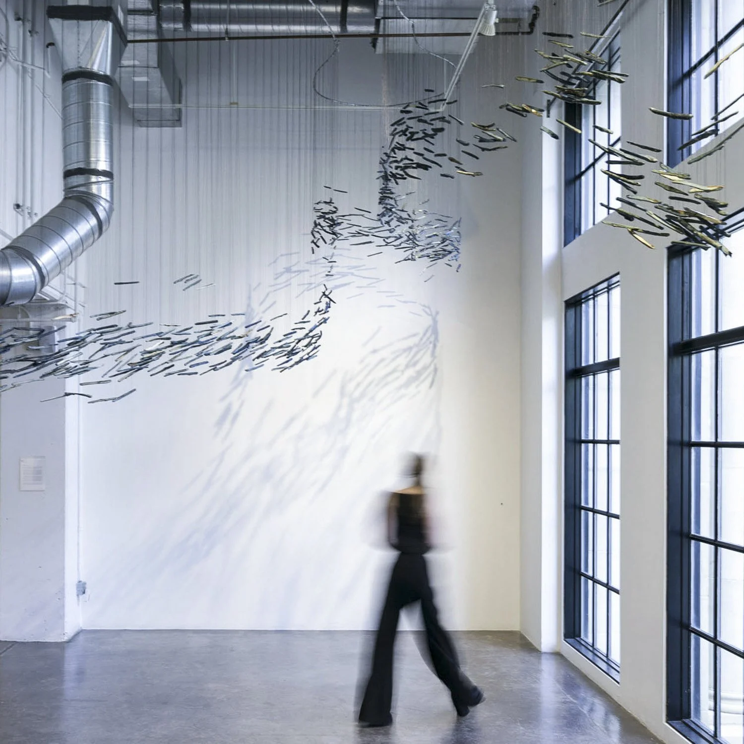 Horseshoe Bend by Theresa Clowes is a dynamic suspended sculpture at the Walker Fine Art Gallery in Denver, inspired by the geological power of the Colorado River that carved out the Horseshoe Bend in Arizona. This intricate contemporary installation