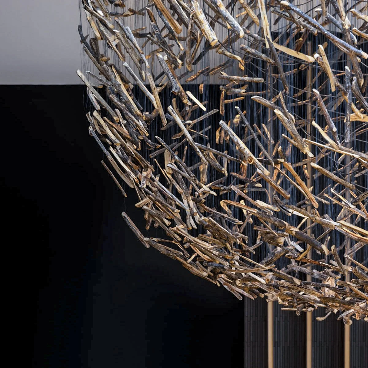 This is a detail of the public art installation by Theresa Clowes titled Possibility. A close-up view of the natural cottonwood sticks within the monumental suspended sculpture. This image highlights the intricate craftsmanship of the installation, s