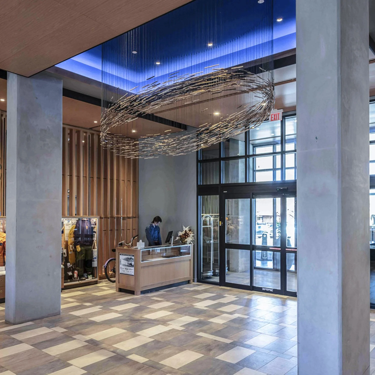 Schooling Possibilities is a circular suspended sculpture resembling a school of fish. This large-scale public art installation by Theresa Clowes is featured in the modern Limelight Hotel in Boulder, Colorado. This site-specific aerial sculpture cons