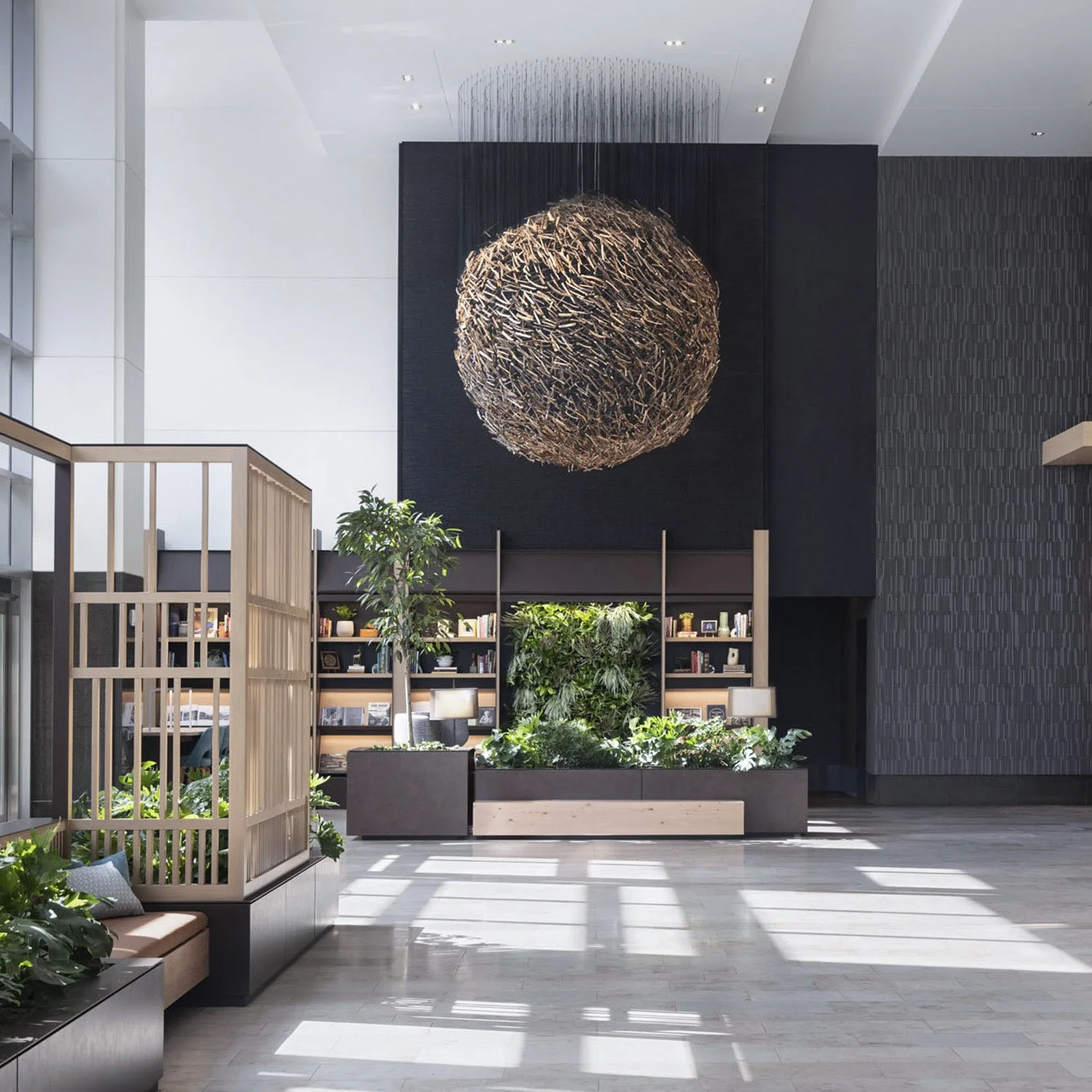 Possibility by Theresa Clowes is a monumental 10 feet by 10 feet spherical suspended sculpture installed in a light-filled, high-end office building lobby in Denver. This permanent public art piece features a dense, intricate weave of 4000 cottonwood