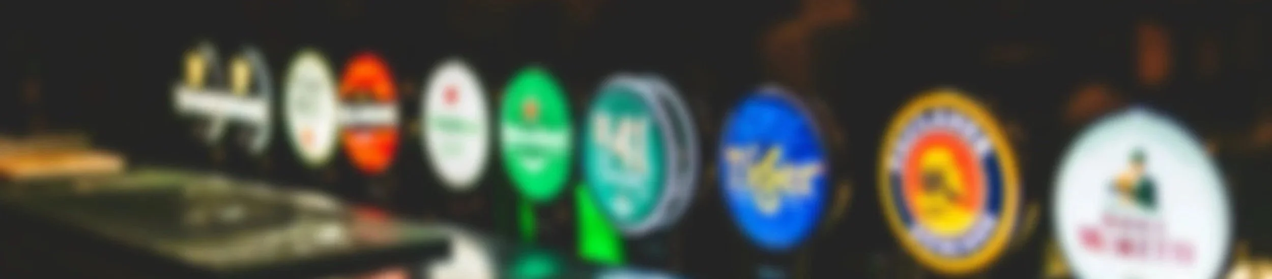 Blurred image of various brightly colored casino slot machine logos and symbols.