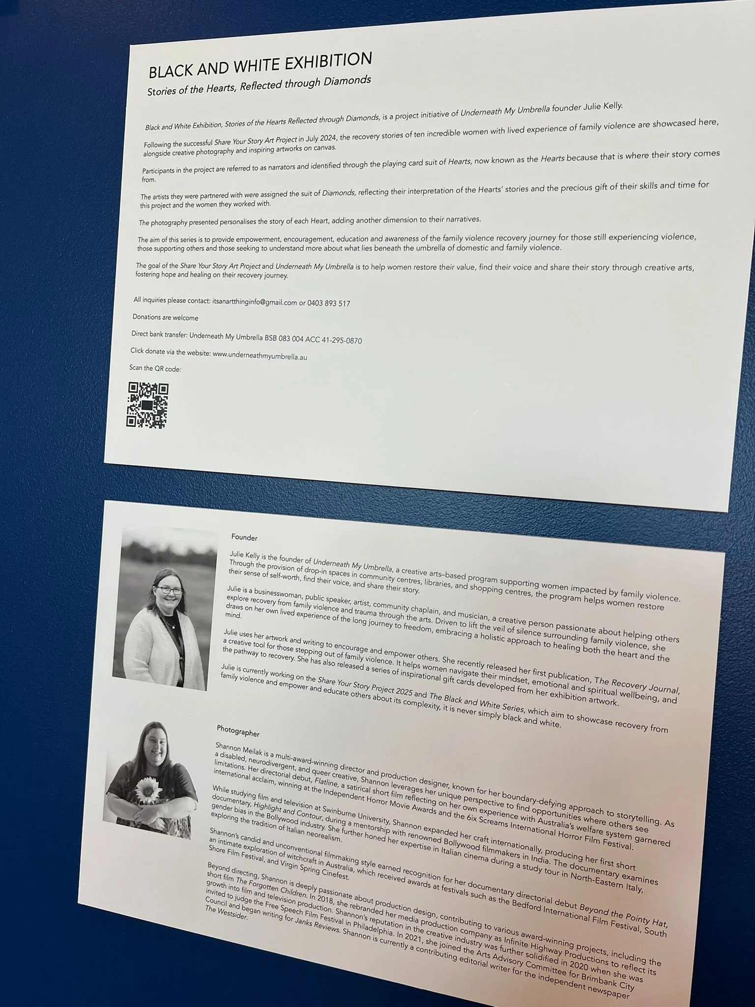 Informational display about the Black and White art exhibition, including text about the project, the artist Julie Kelly, and the photographer Shannon Melik, with two black and white portraits of the artist and the photographer.
