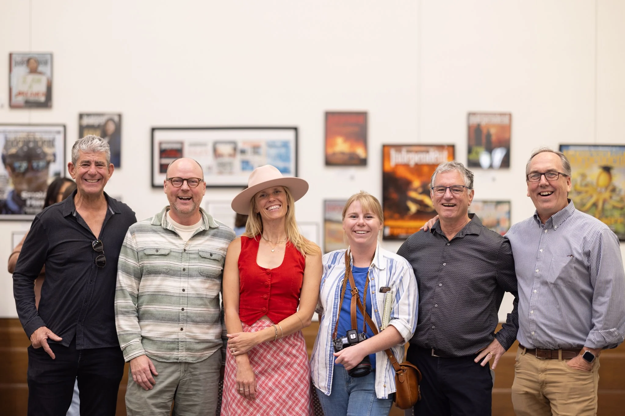 Friends smiling in front of exhibit
