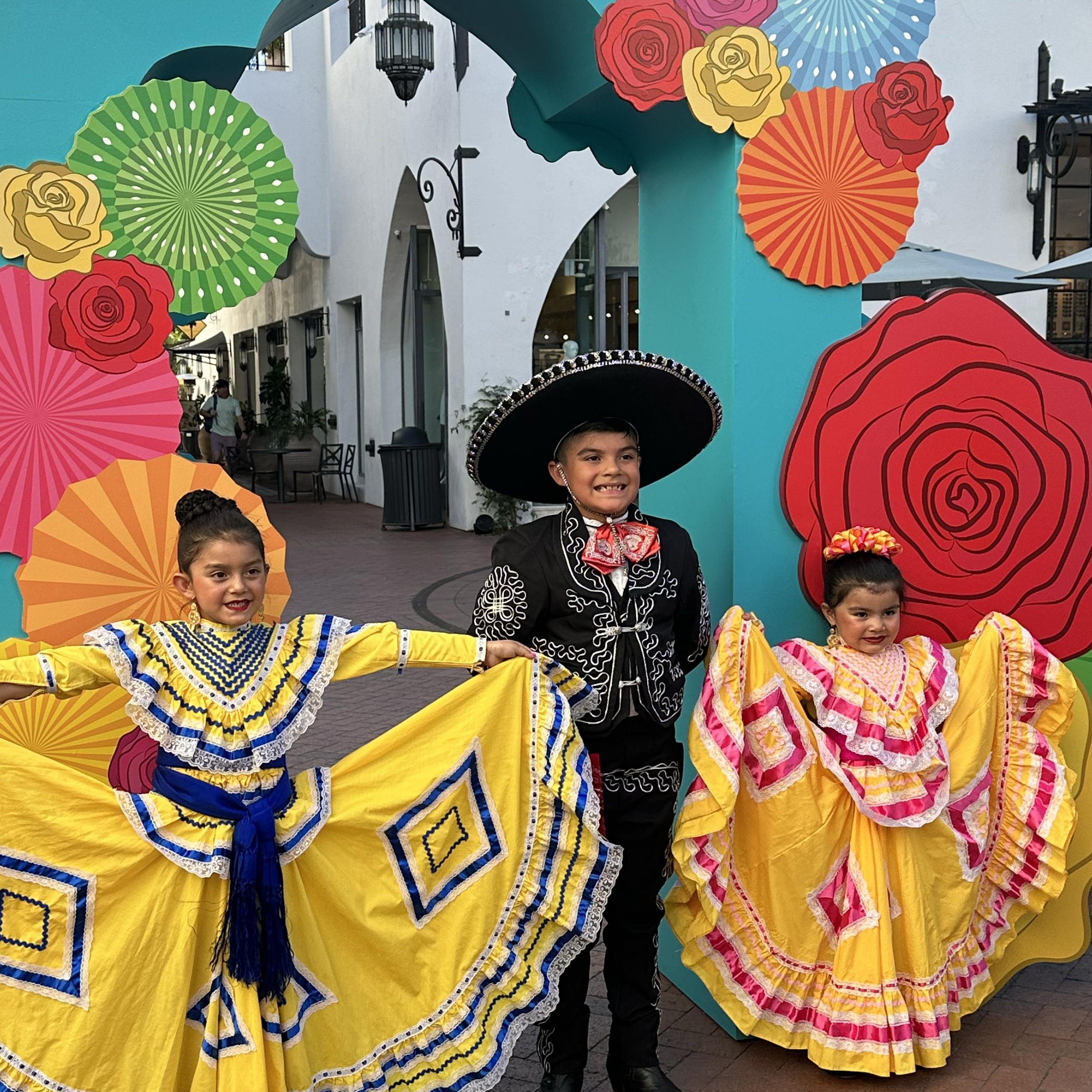 Three children in traditional Mexican costumes