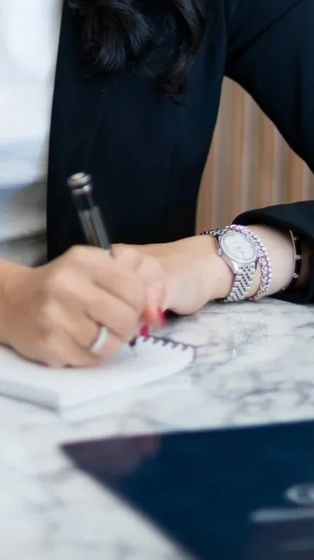 Brook Choulet, M.D. writing on notepad