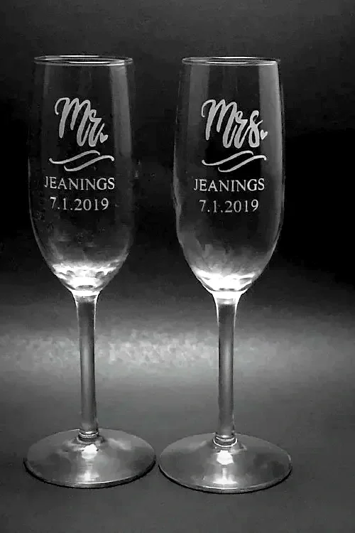 Two champagne flutes with 'Mr.' and 'Mrs.' engraved, along with the name 'Jeanings' and the date '7.1.2019'.
