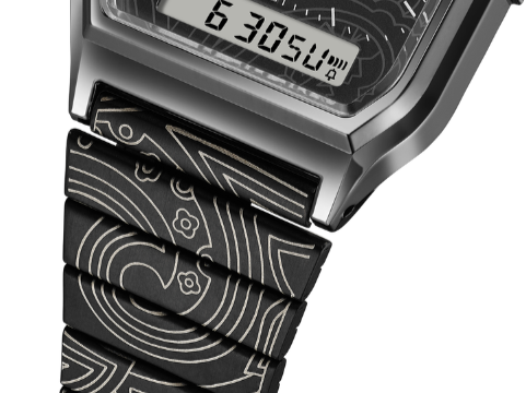 Close-up of a digital watch with a patterned black strap.