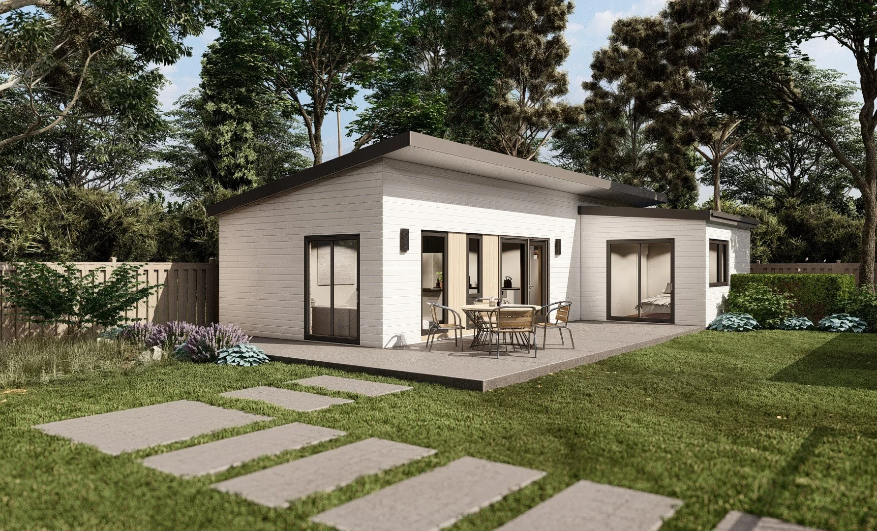 Modern, single-story house with white exterior, large glass sliding doors, a patio with outdoor furniture, surrounded by green lawn, trees, and landscaped garden.