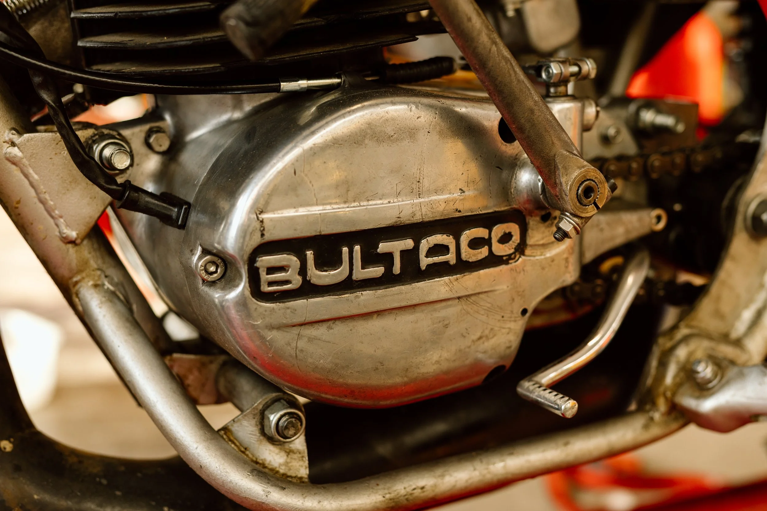 Close-up of a vintage motorcycle engine displaying the brand name 'BULTACO' on the metal cover.
