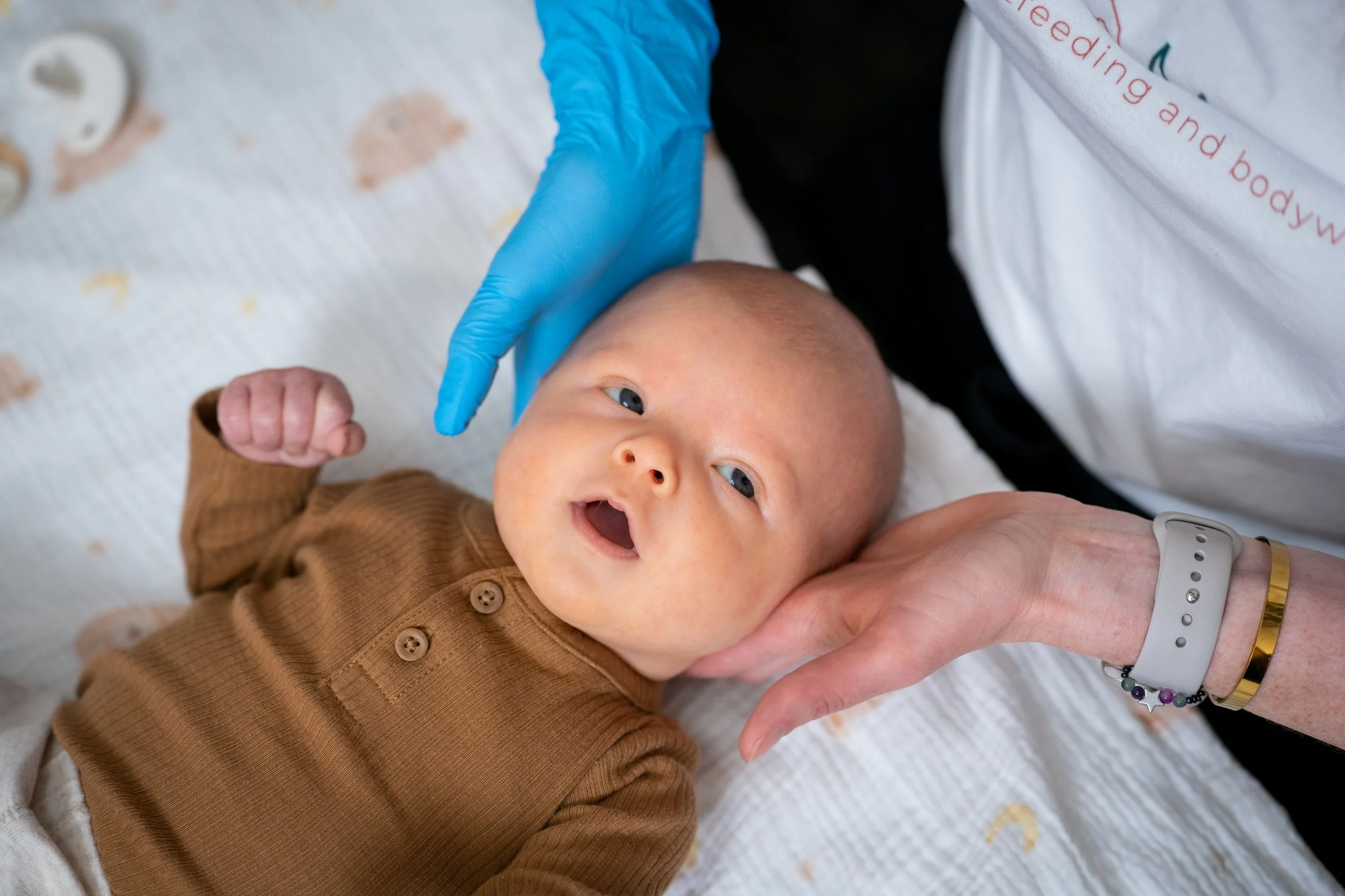 Gentle infant bodywork to support nervous system regulation and feeding comfort