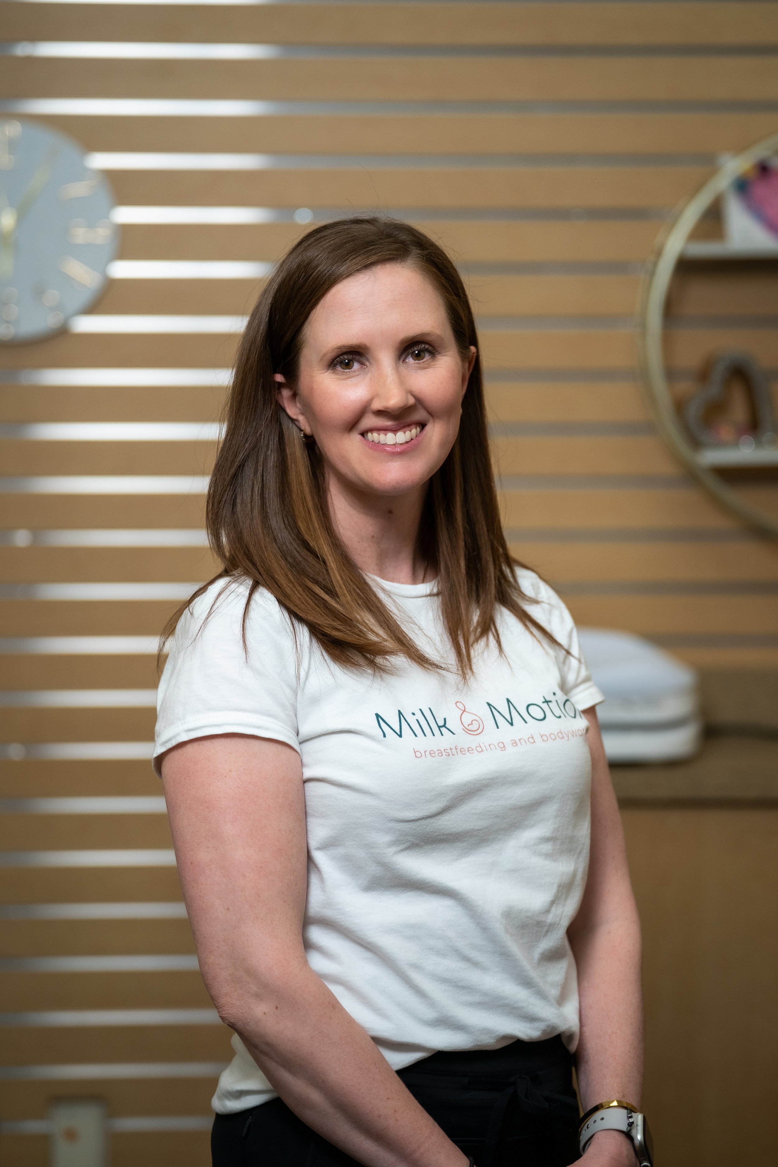 Jennifer Matthews, Family Nurse Practitioner and IBCLC, smiling with a client