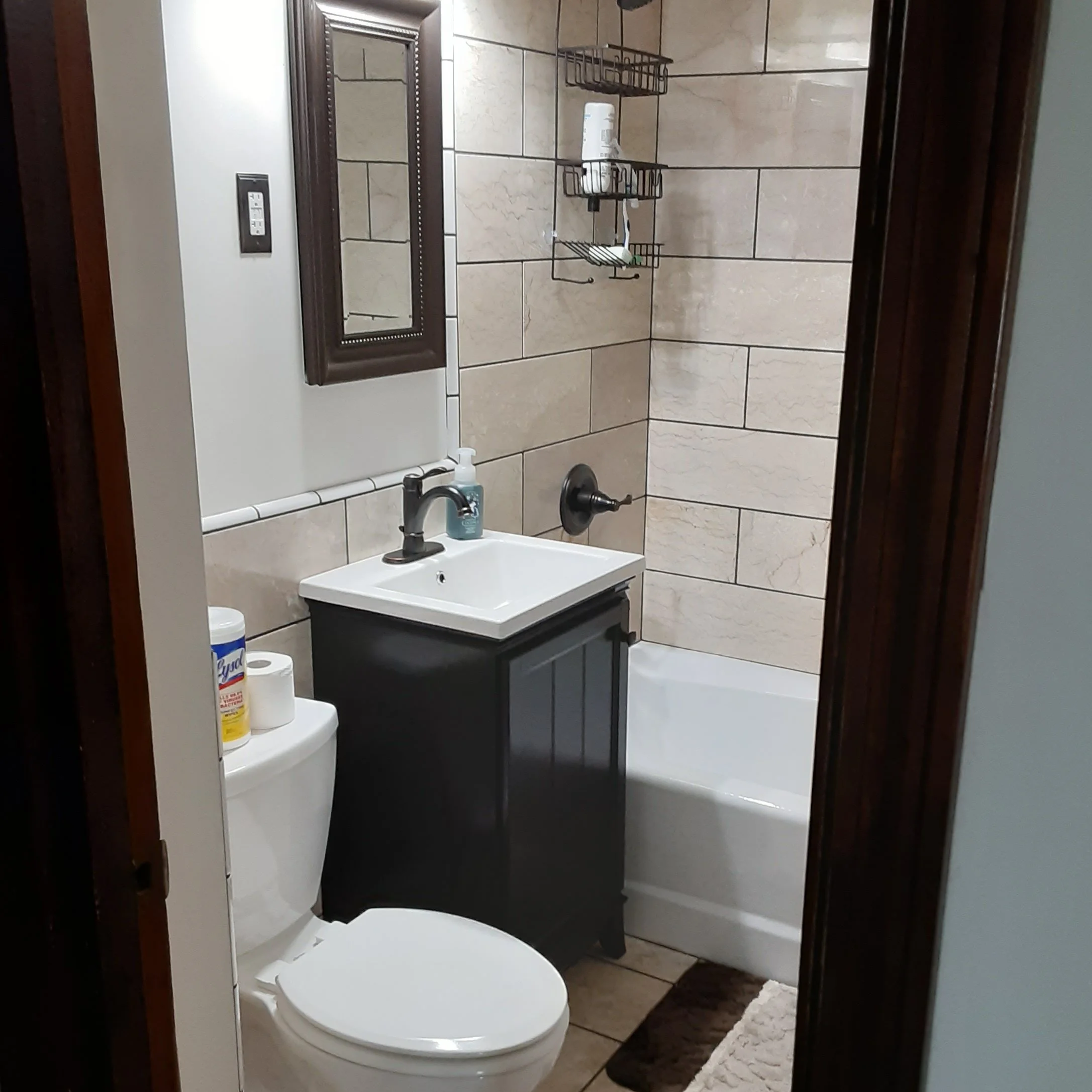 Finished bathroom remodel with new tile, new sink, new tub, new flooring. expertly handcrafted. 