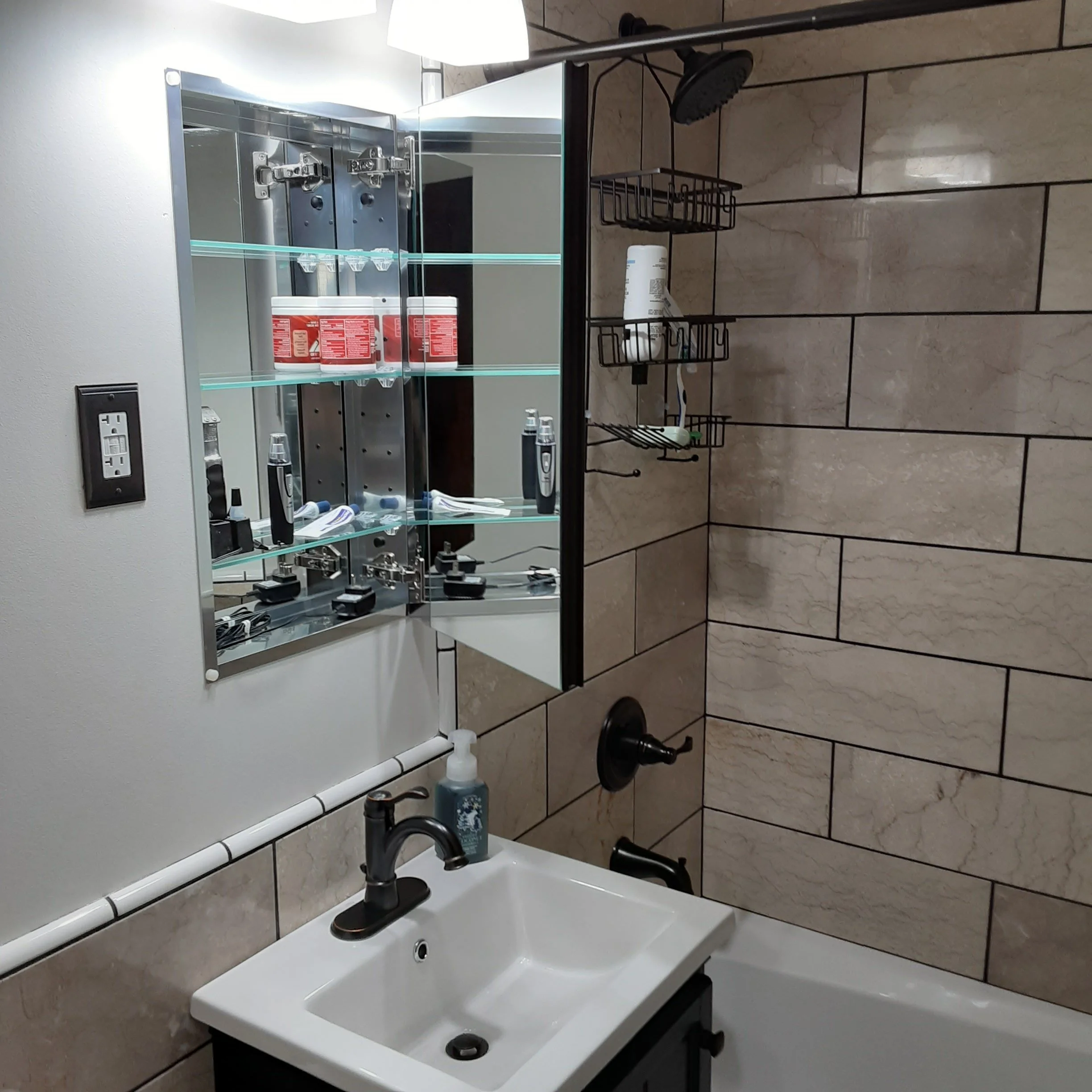 Finished bathroom remodel with new tile, new sink, new tub, new flooring. expertly handcrafted. 