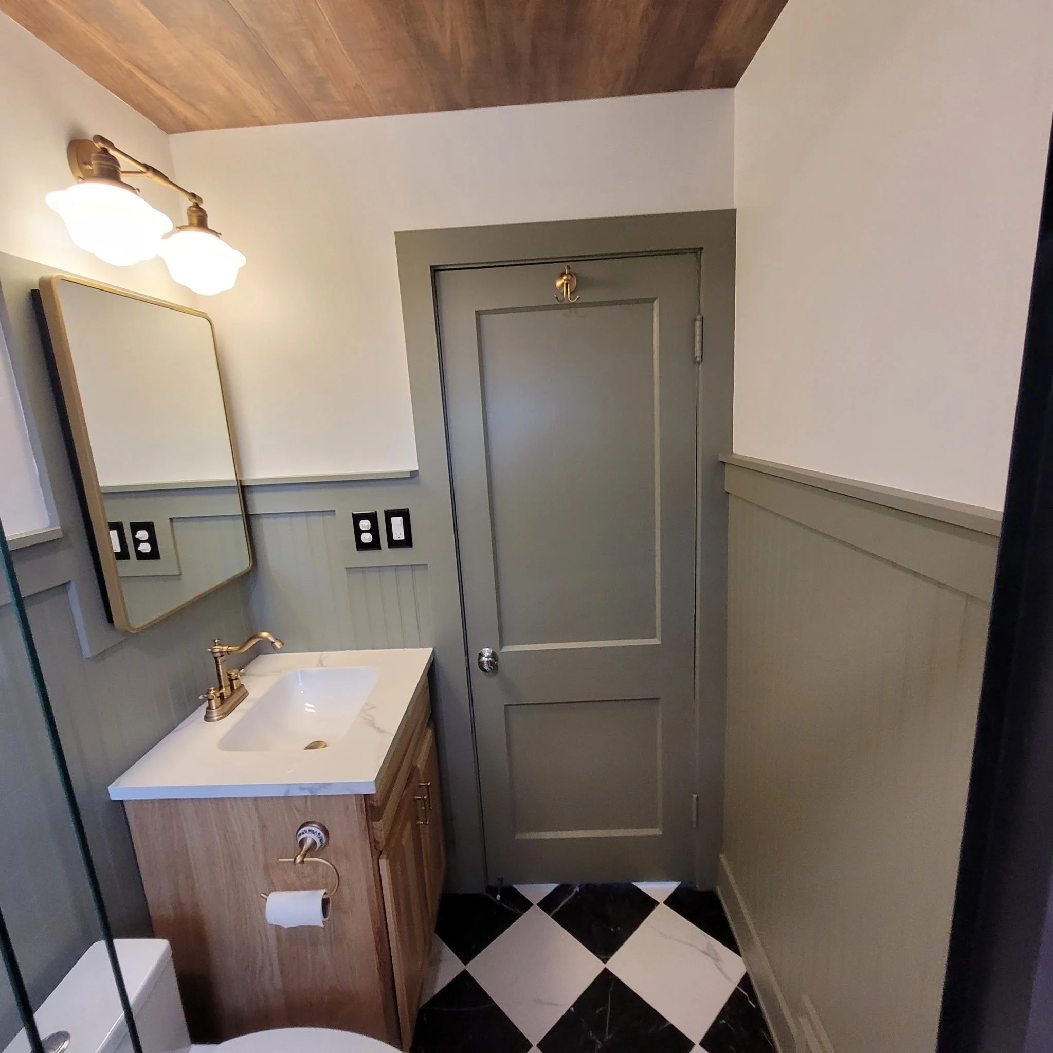 Finished bathroom remodel with checkered flooring, wood ceiling and beam, updated shower and vanity with a farm house feel.