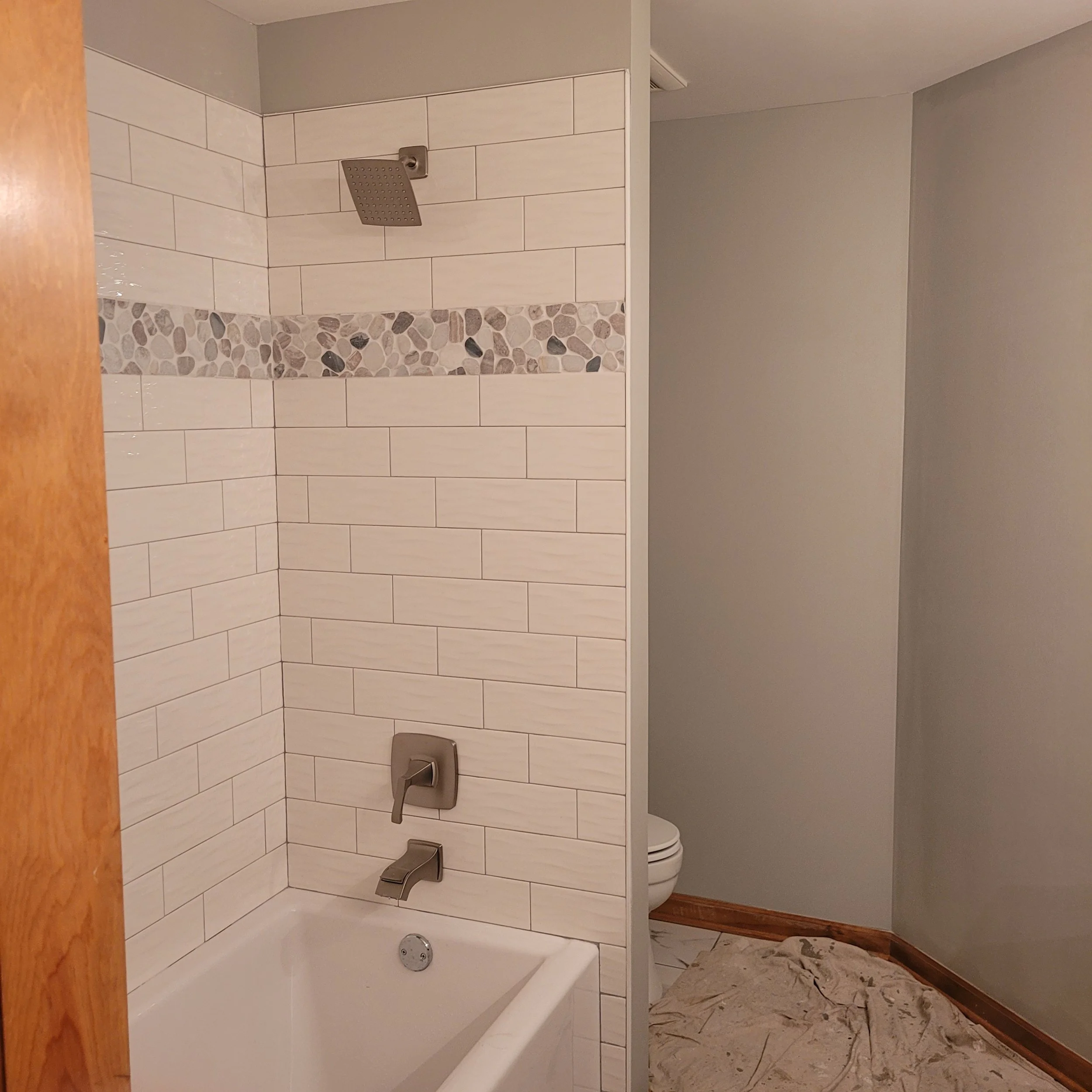 new bath tub in finish remodel with beautiful tile work