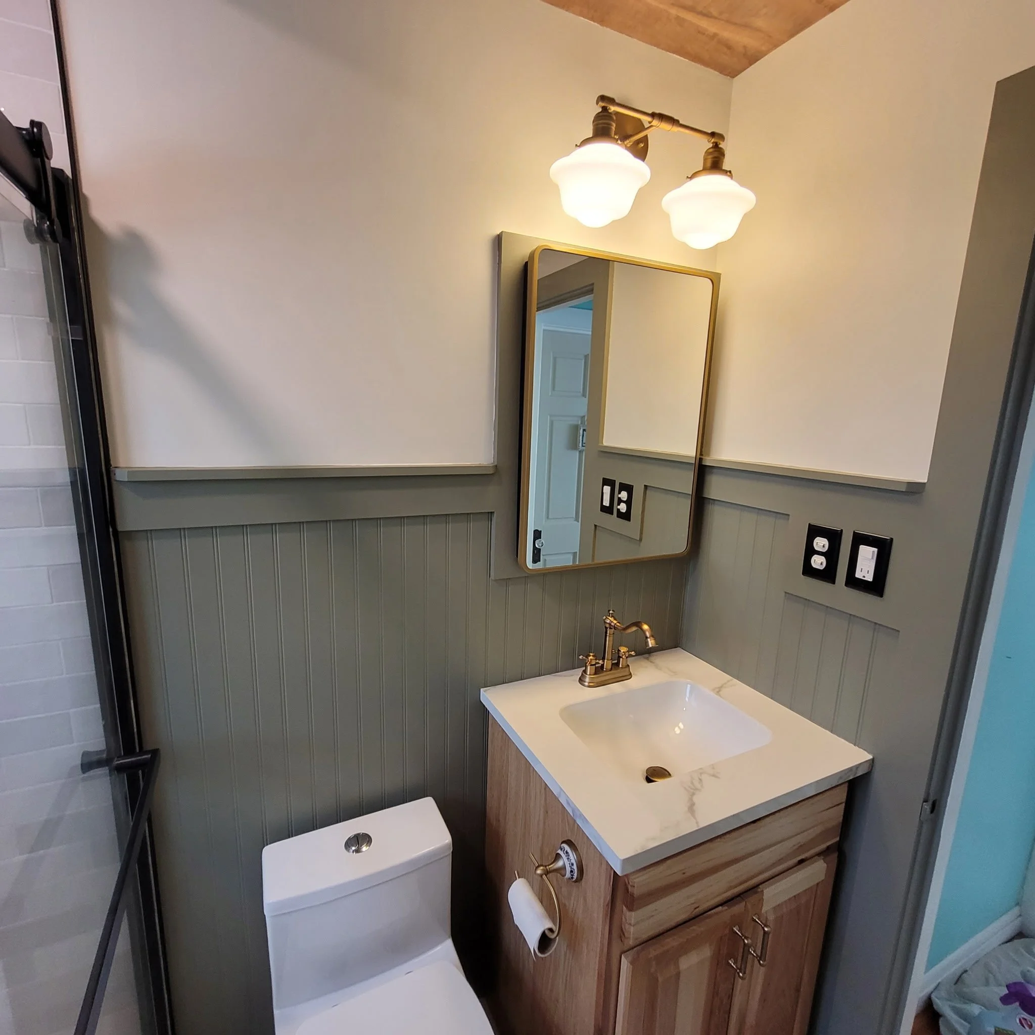 Finished bathroom remodel with checkered flooring, wood ceiling and beam, updated shower and vanity, new eco-toilet,  with a farm house feel.