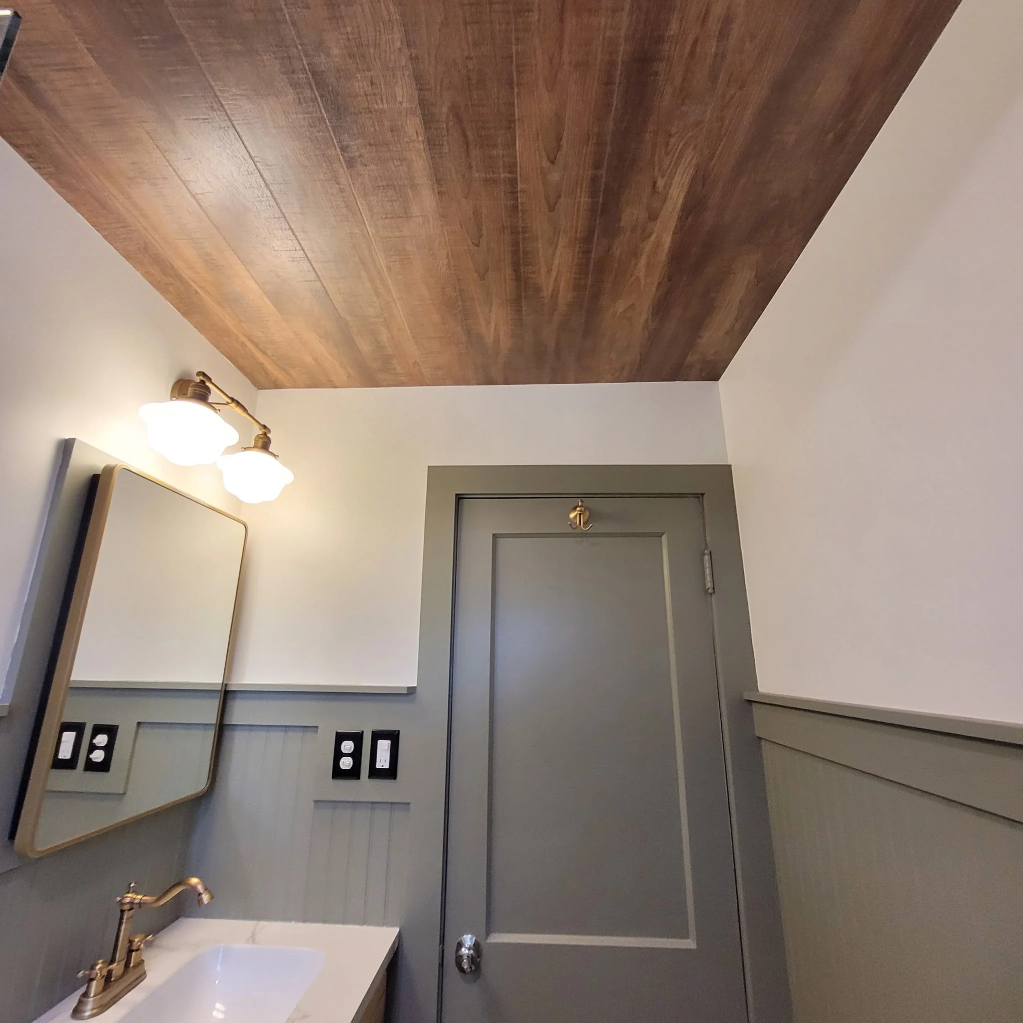 Finished bathroom remodel with checkered flooring, wood ceiling and beam, updated shower and vanity with a farm house feel.