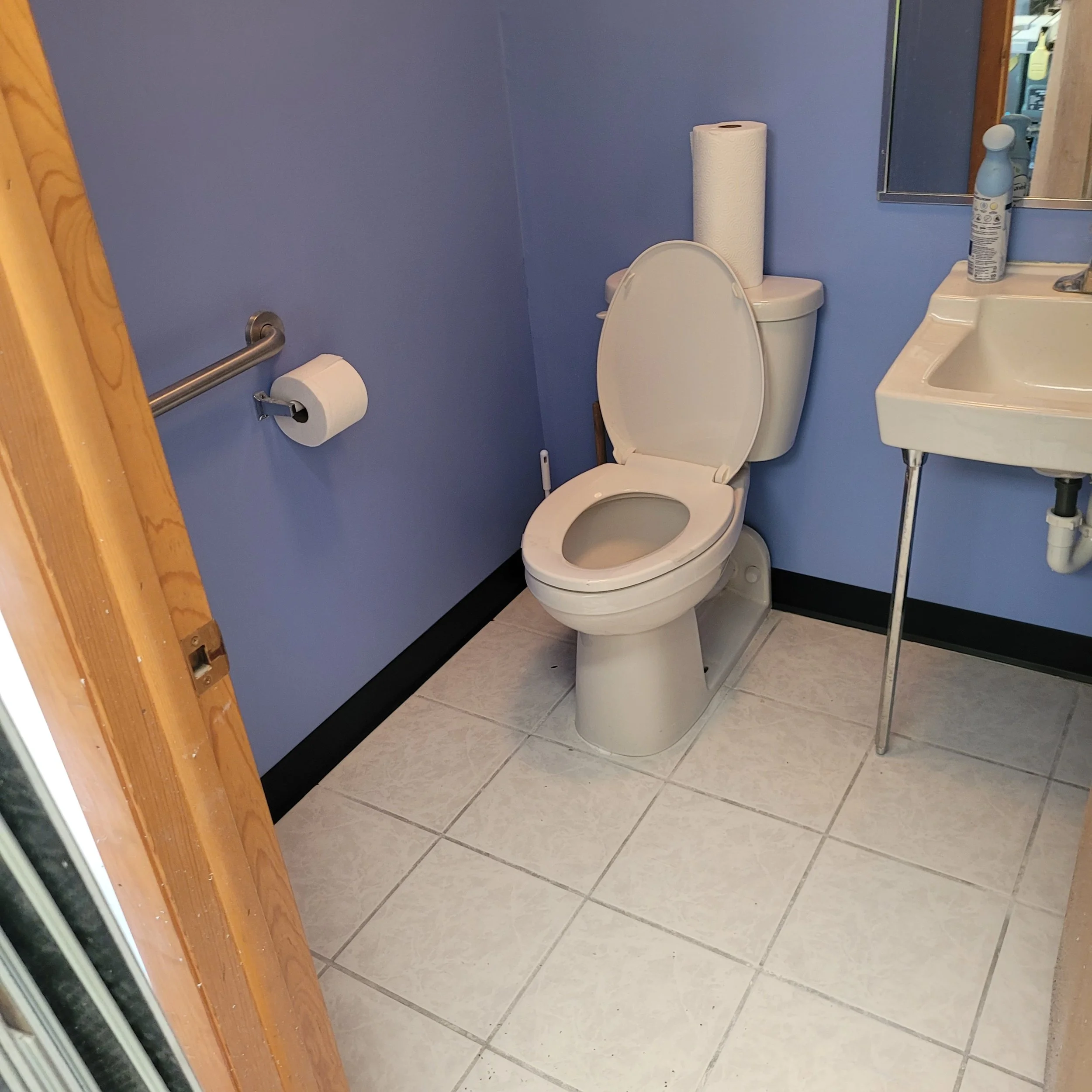 Finished small office bathroom remodel with new flooring, new ceiling, and a fresh new paint job