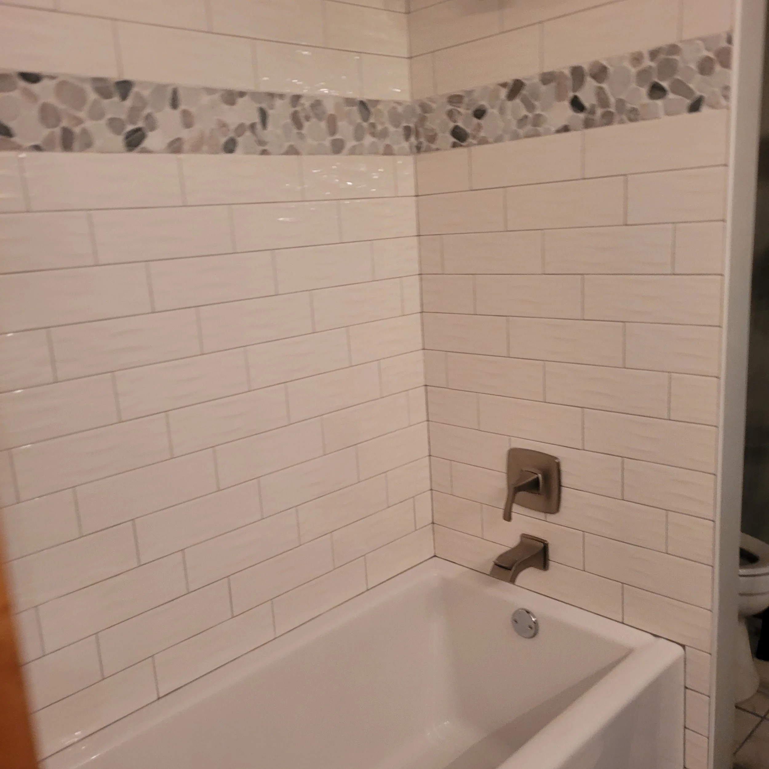 new bath tub in finish remodel with beautiful tile work