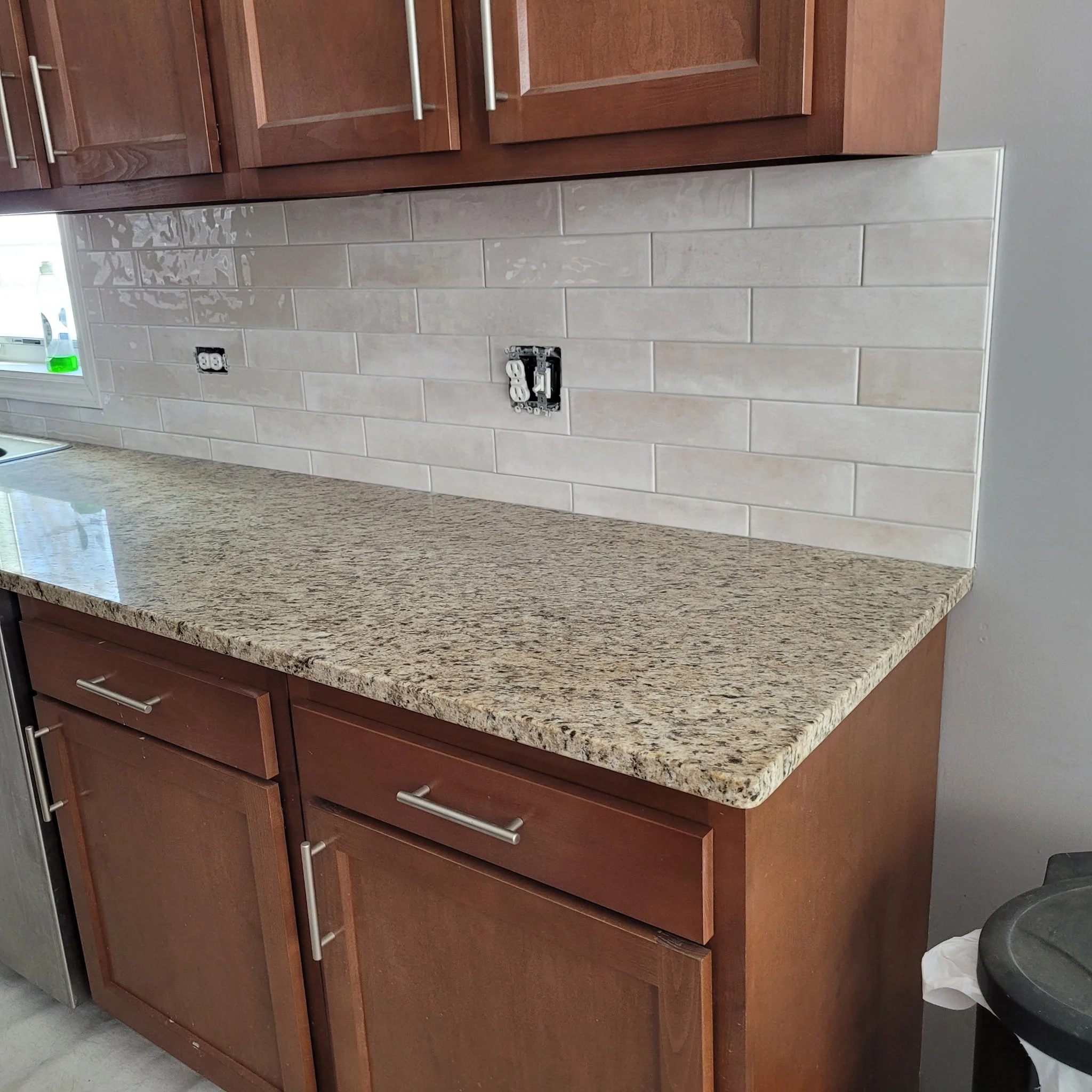 Finished kitchen remodel with new cabinets, counter tops, subway backsplash, country sink, new flooring built with a modern touch.