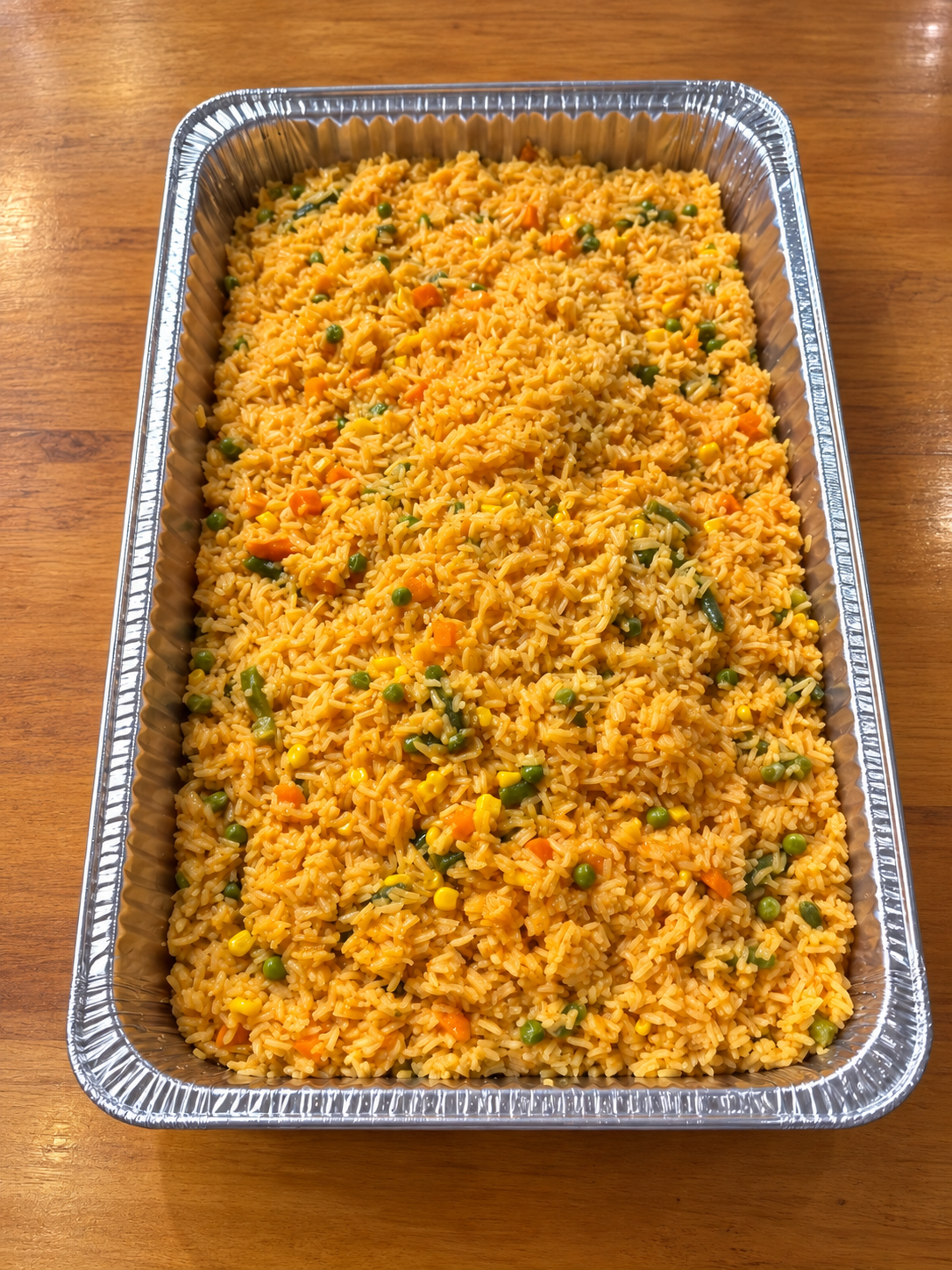 Warm vegetable rice in foil tray.png