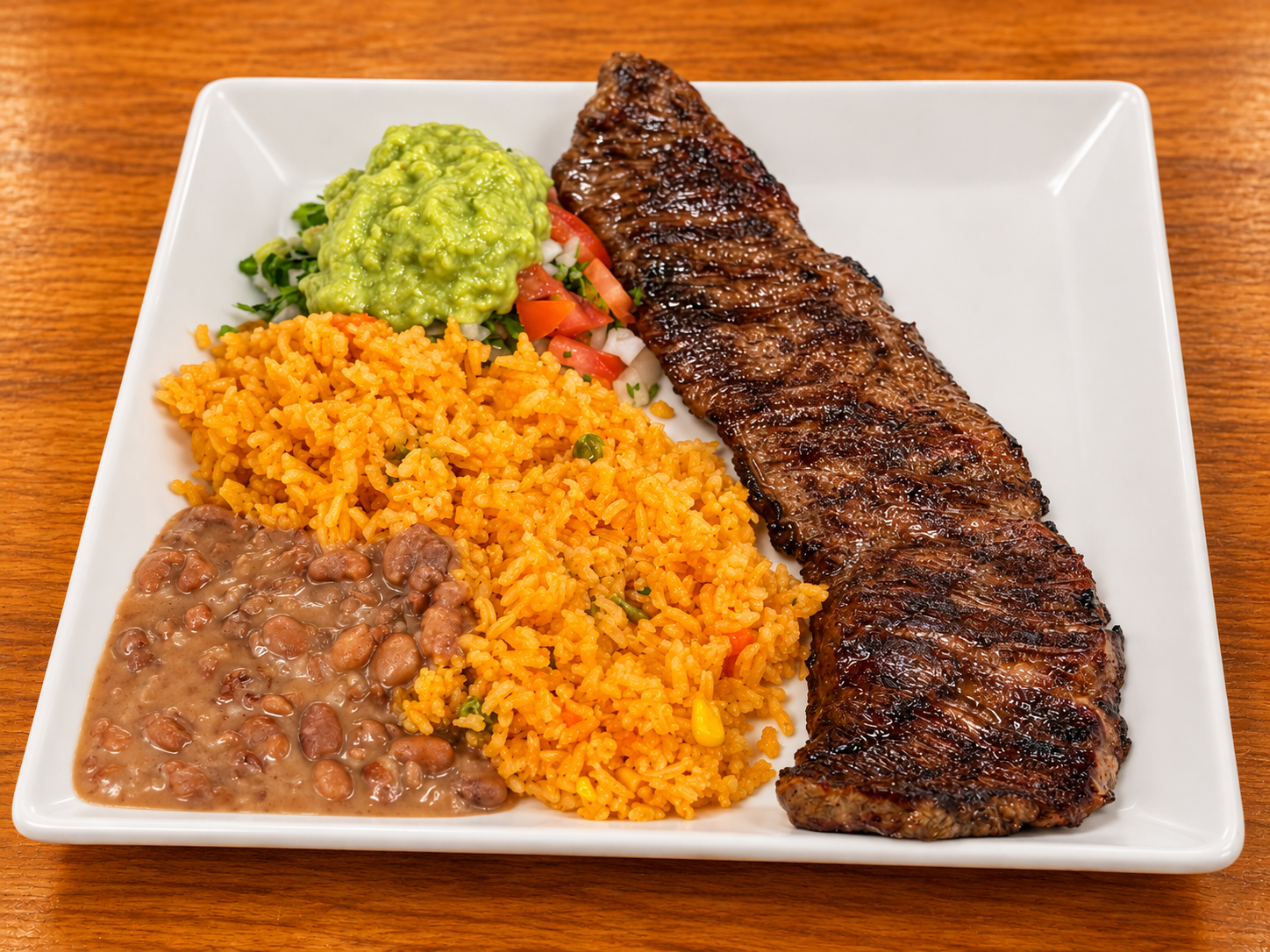 Grilled steak with Mexican sides.png