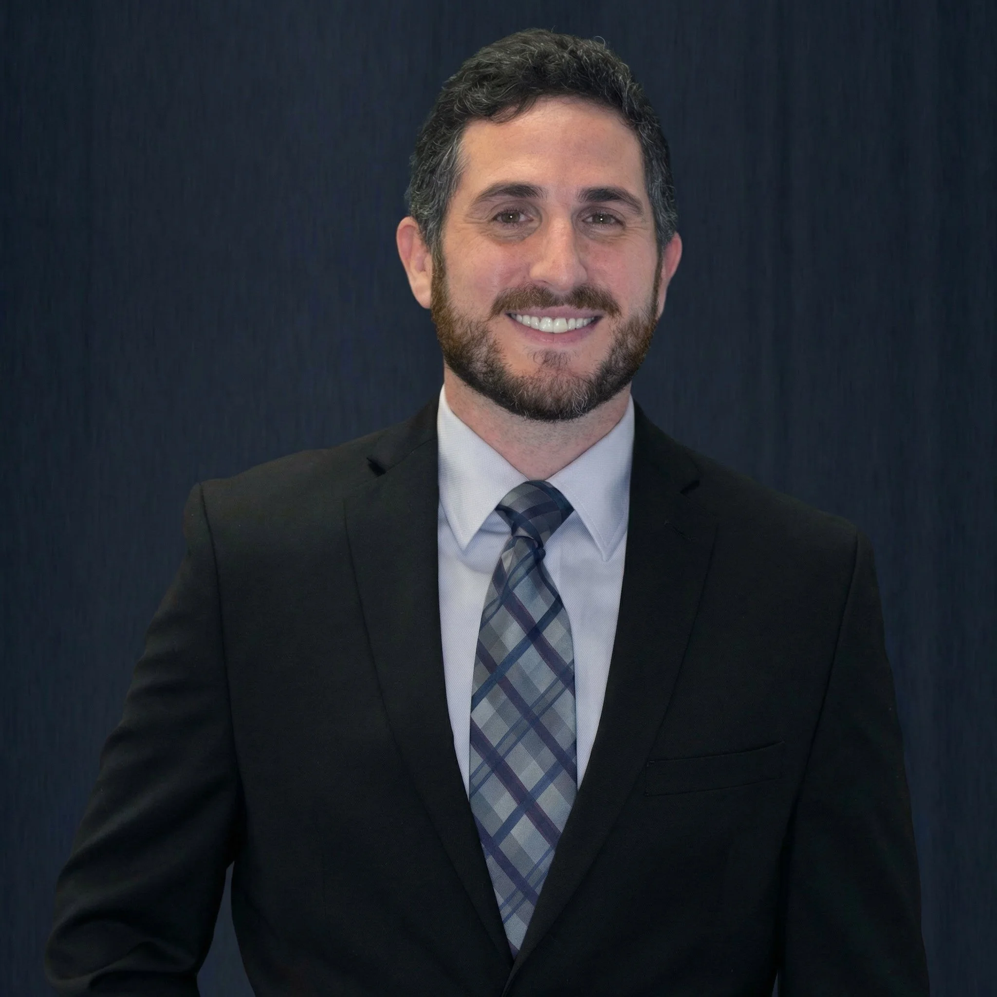 A headshot of David Feingold, employment attorney, in a black suit.