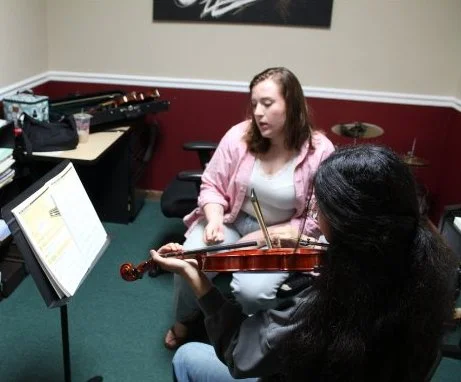 Carlyn teaching a former beginner violin student.
