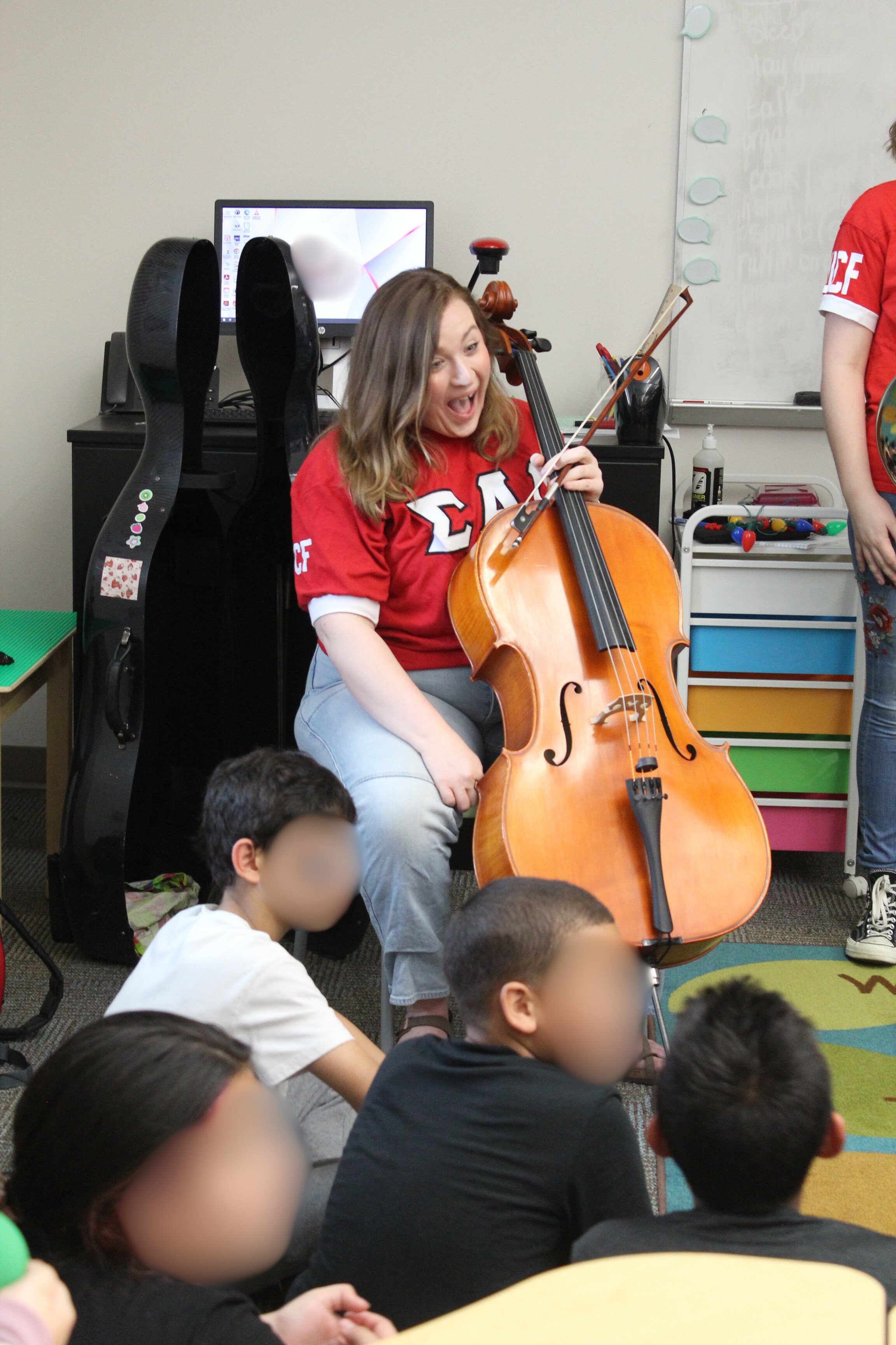 Carlyn introducing the cello to elementary school children.