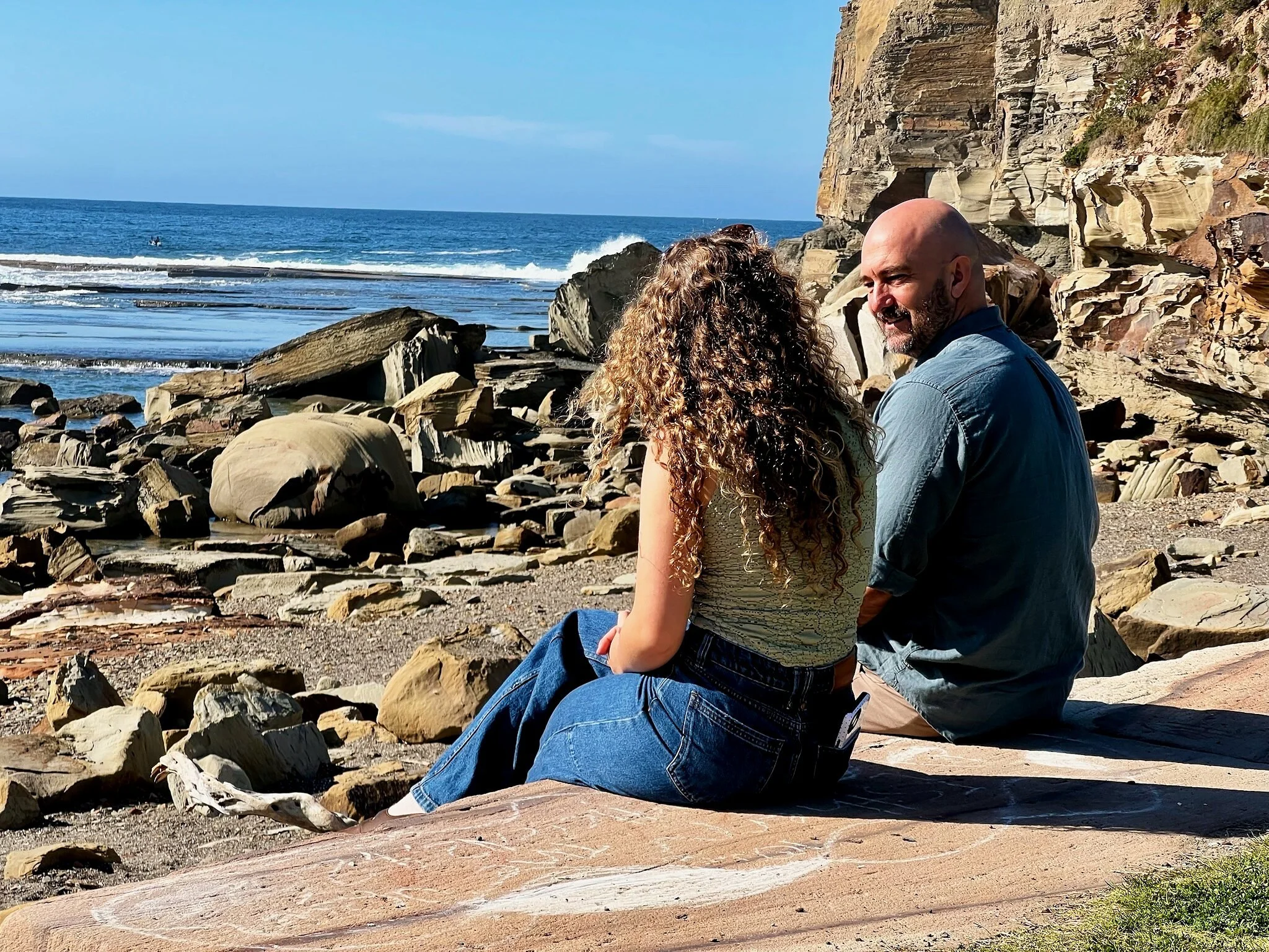 Greg speaking with a female client during an ADHD coaching session at Terrigal Beach
