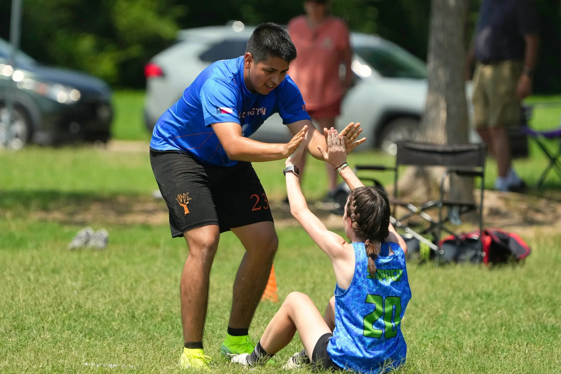 Sugar High's Gerardo Vazquez helps up teammate Skipper Guilbeau during a game at Two Finger in 2025.