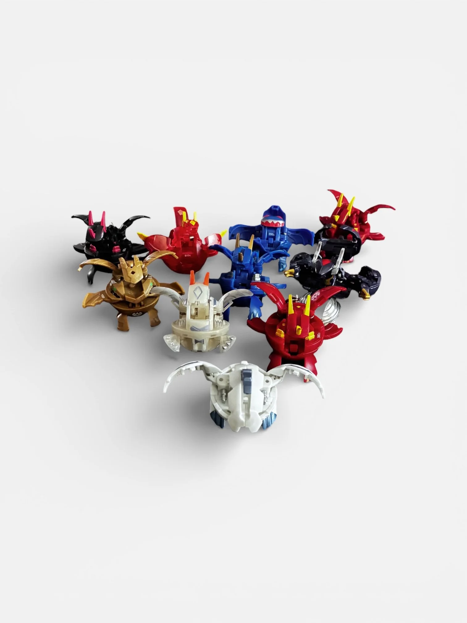 Collection of stylized dragon and creature figures arranged in a heart shape on a white background.