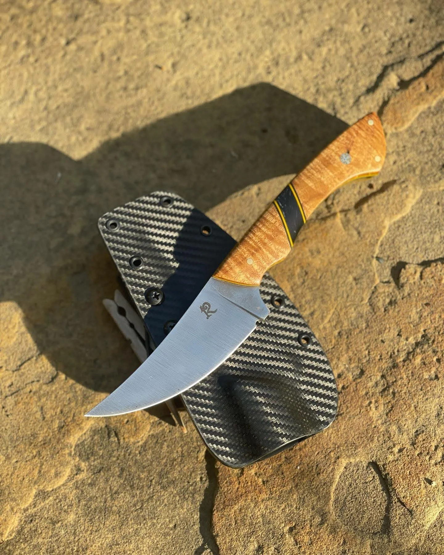 My first hunter: a skinner. Magnacut steel. Handle is Amboyna burl with truestone and yellow vp spacers.  A gift for my brother Jon (2023)