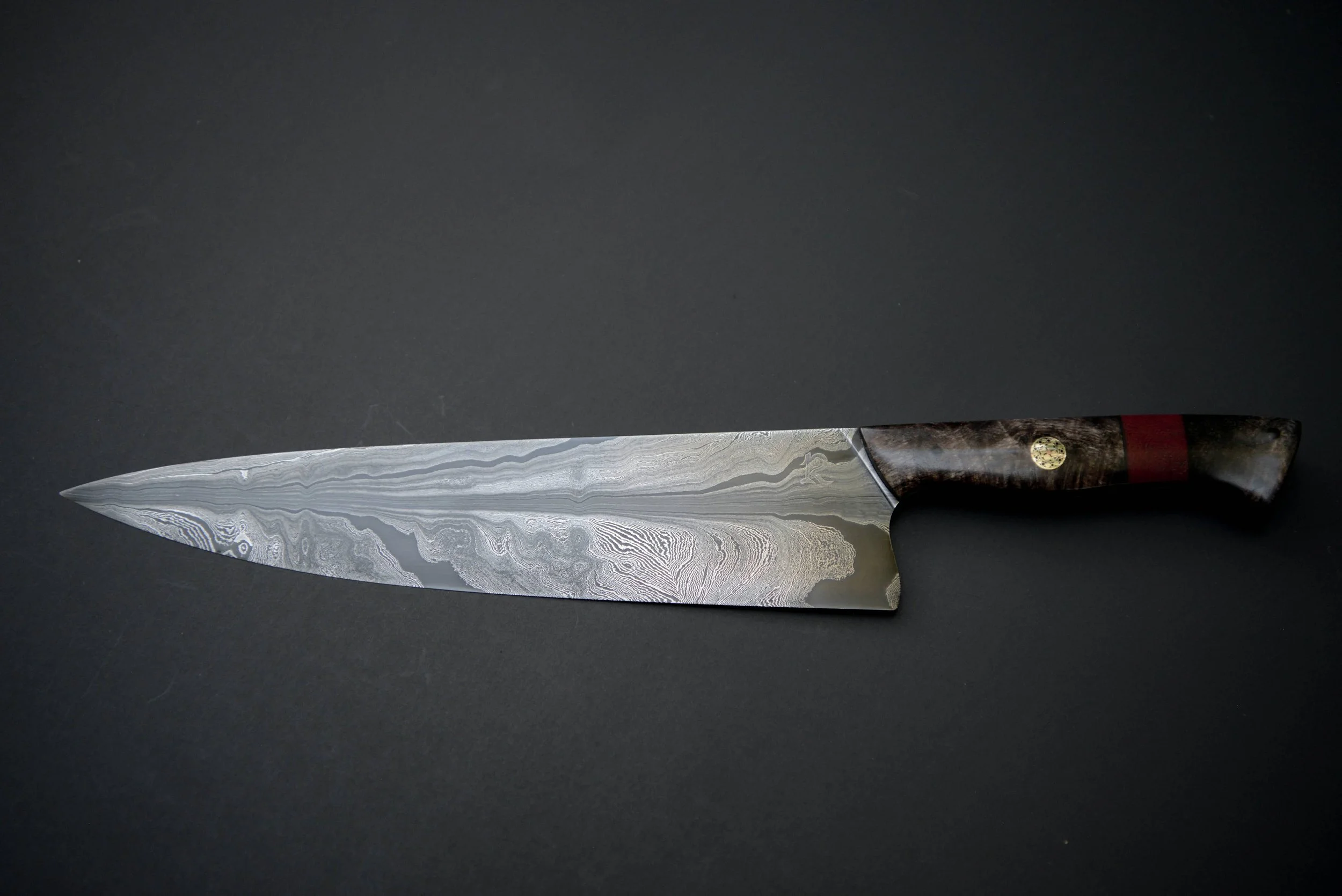 Random pattern damascus aggressively feathered. A very early blade and still one of my favorites (2023)
