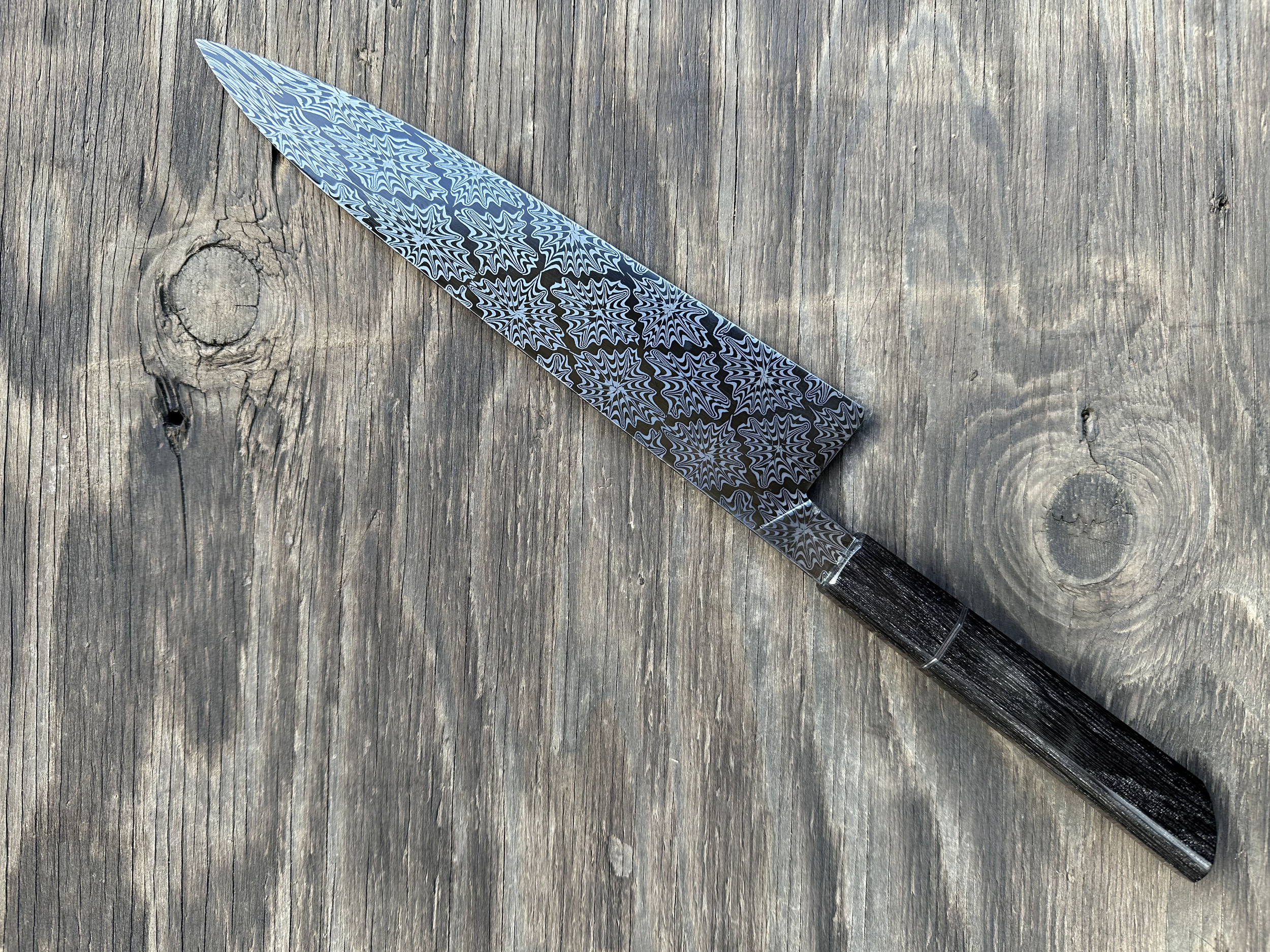 9 inch Gyuto. Explosion damascus pattern of 1095 and 15n20 steels. Handle is bog oak with stainless steel spacer (2024)