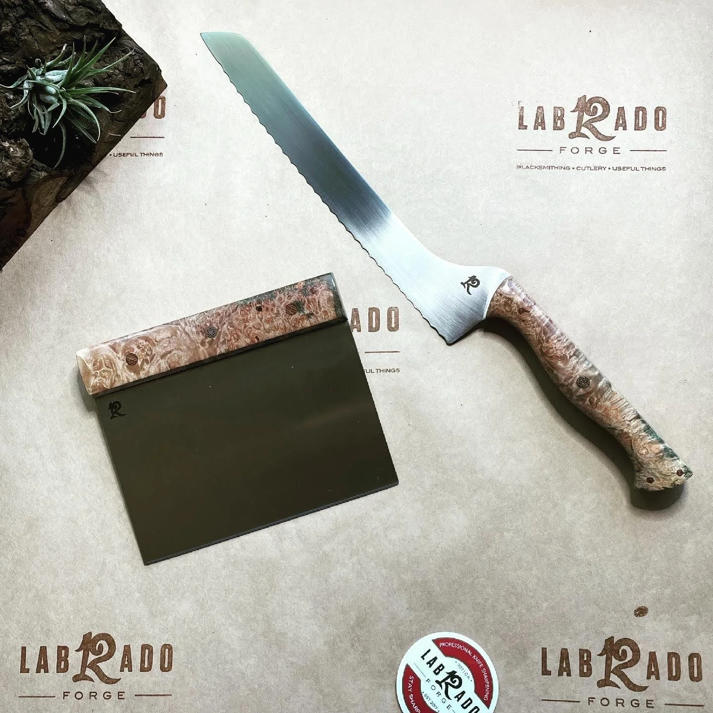 Offset bred knife and board scraper commission for a baker. Blades are Nitro-V stainless. Handles are natural Maple burl