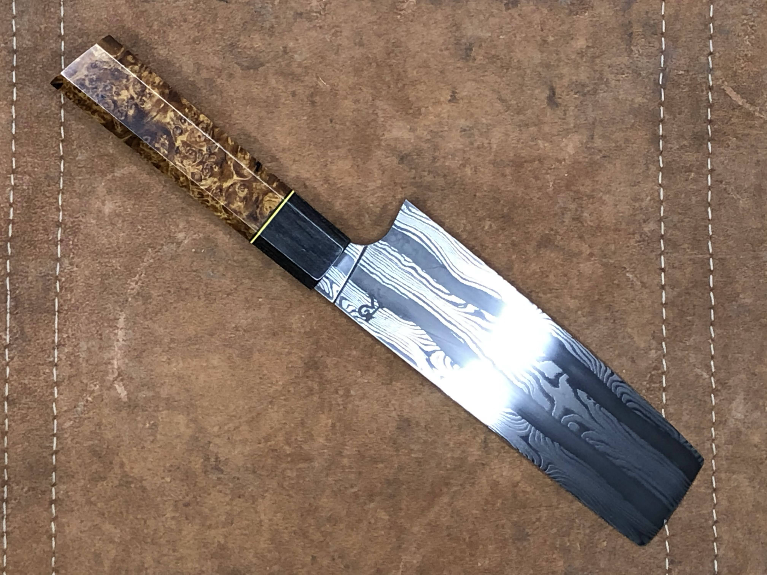Multi-bar damascus Nakiri.1095 and 15n20. Handle is amboyna and bog oak with black and white micarta spacers (2021)