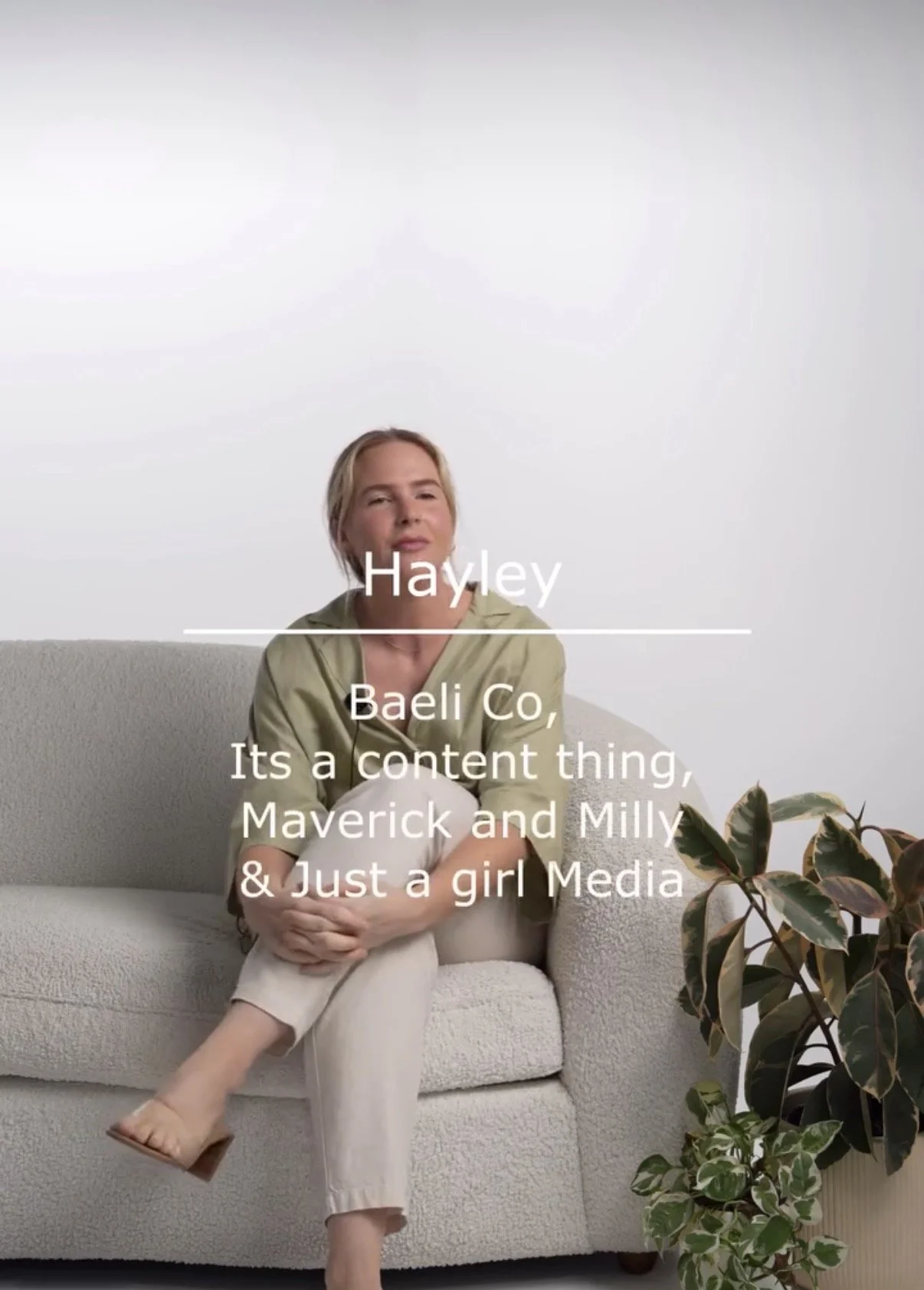 A woman sitting on a neutral-colored sofa with a plant next to her, with white text overlaid that reads: "Hayley, Baeli Co, It's a content thing, Maverick and Milly & Just a girl Media".
