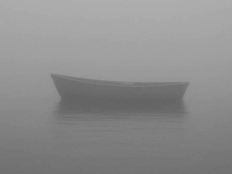 Lonely boat in the mist