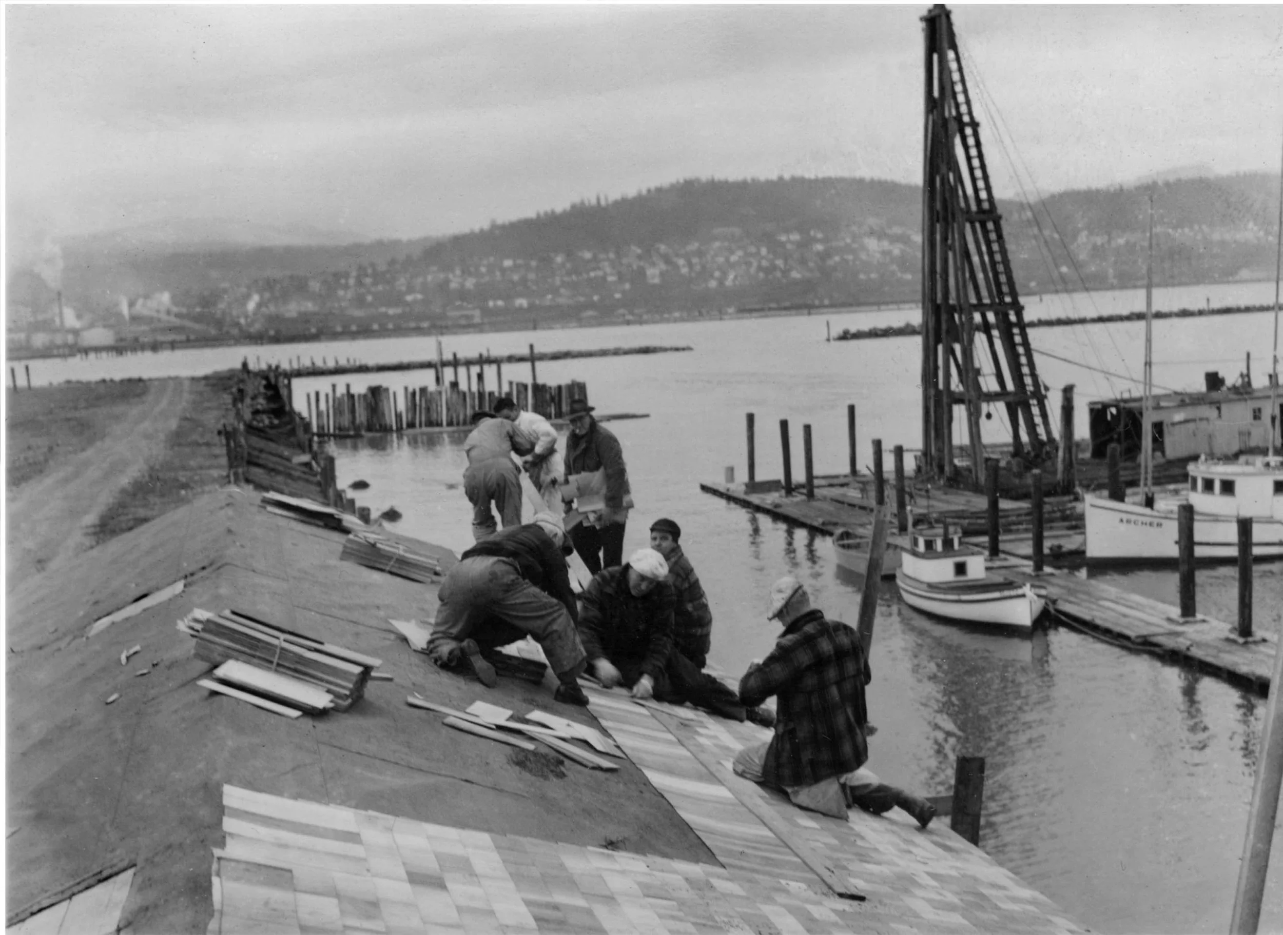 Some Squalicum Yacht Club members install shingles on the newly relocated clubhouse at Squalicum Harbor.