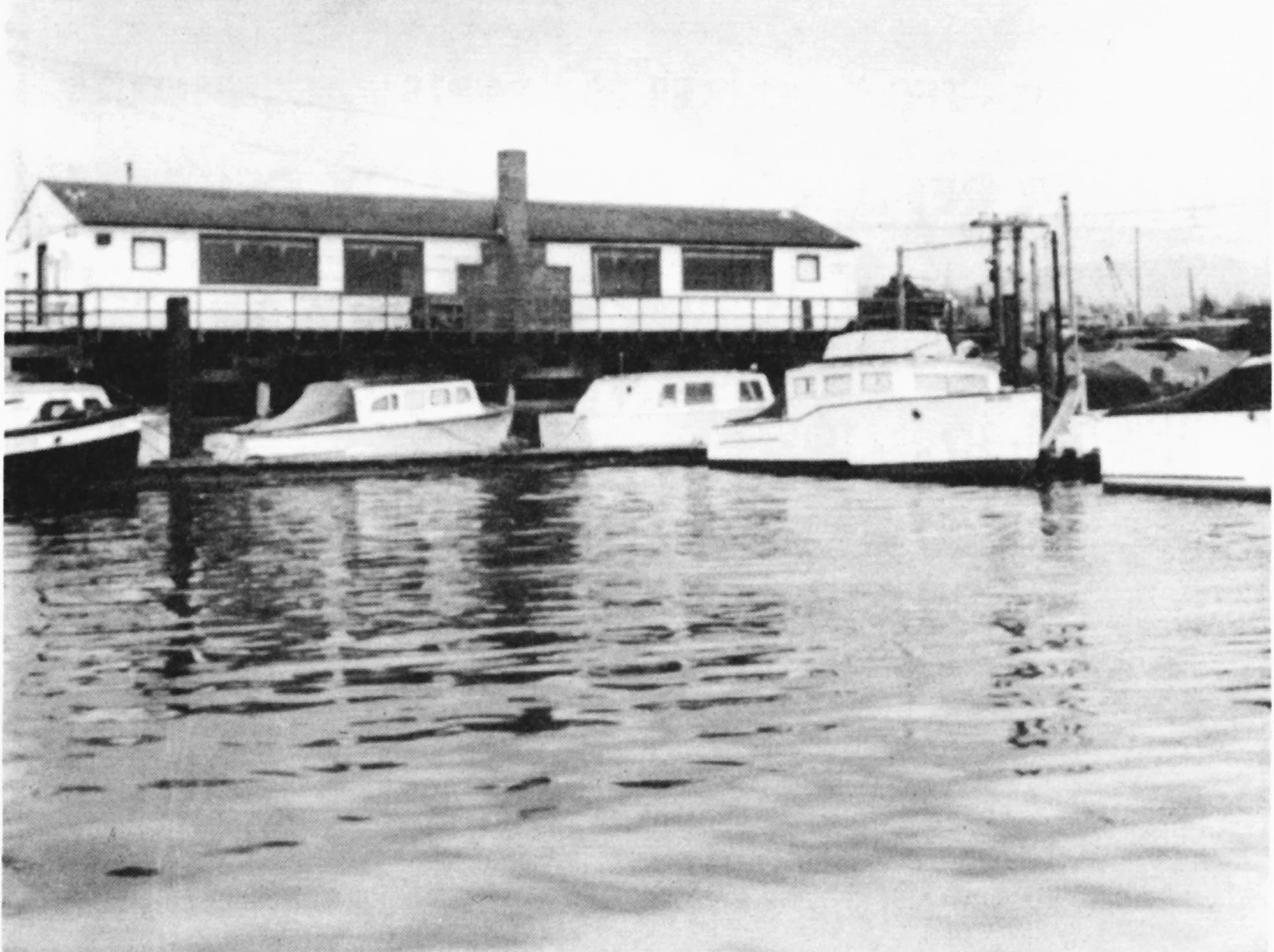 Black and white photograph of the Squalicum Yacht Club clubhouse at Squalicum Harbor.