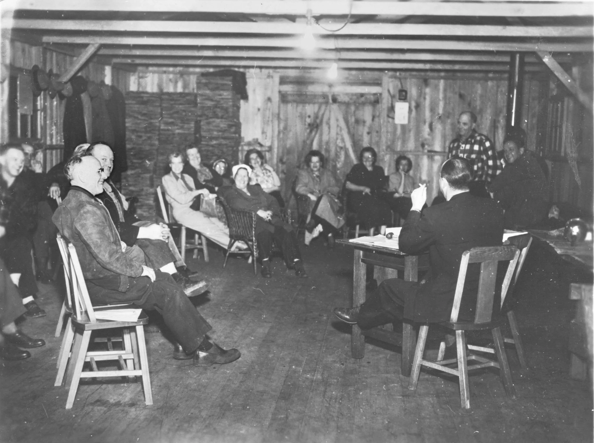 A black and white photo of the club's first meeting in the new clubhouse.