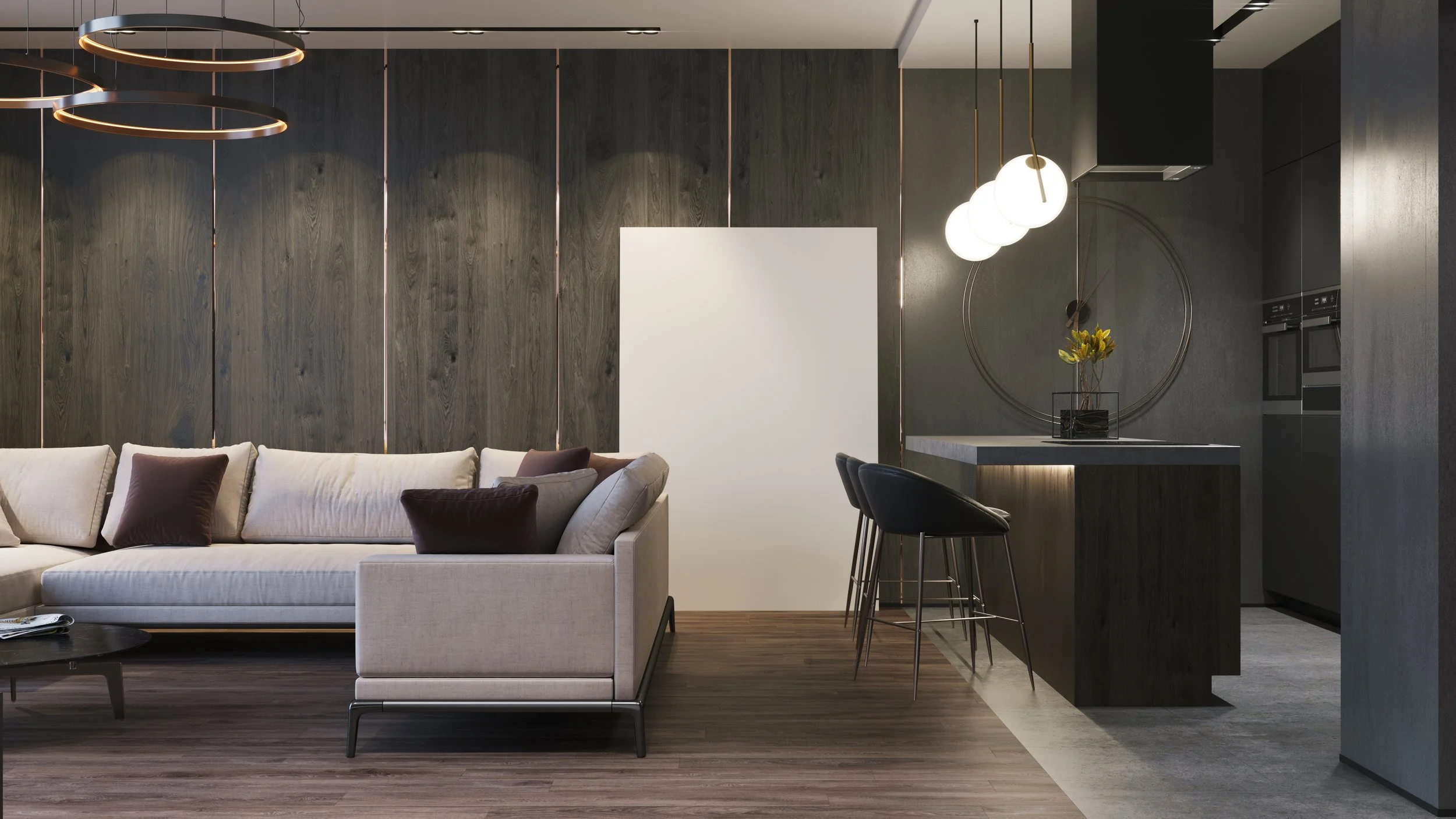 Modern living room with a beige sofa, dark throw pillows, wooden wall panels, a coffee table, and a kitchen area with a dark island, four black barstools, pendant lights, and a wall clock with flowers in a vase.
