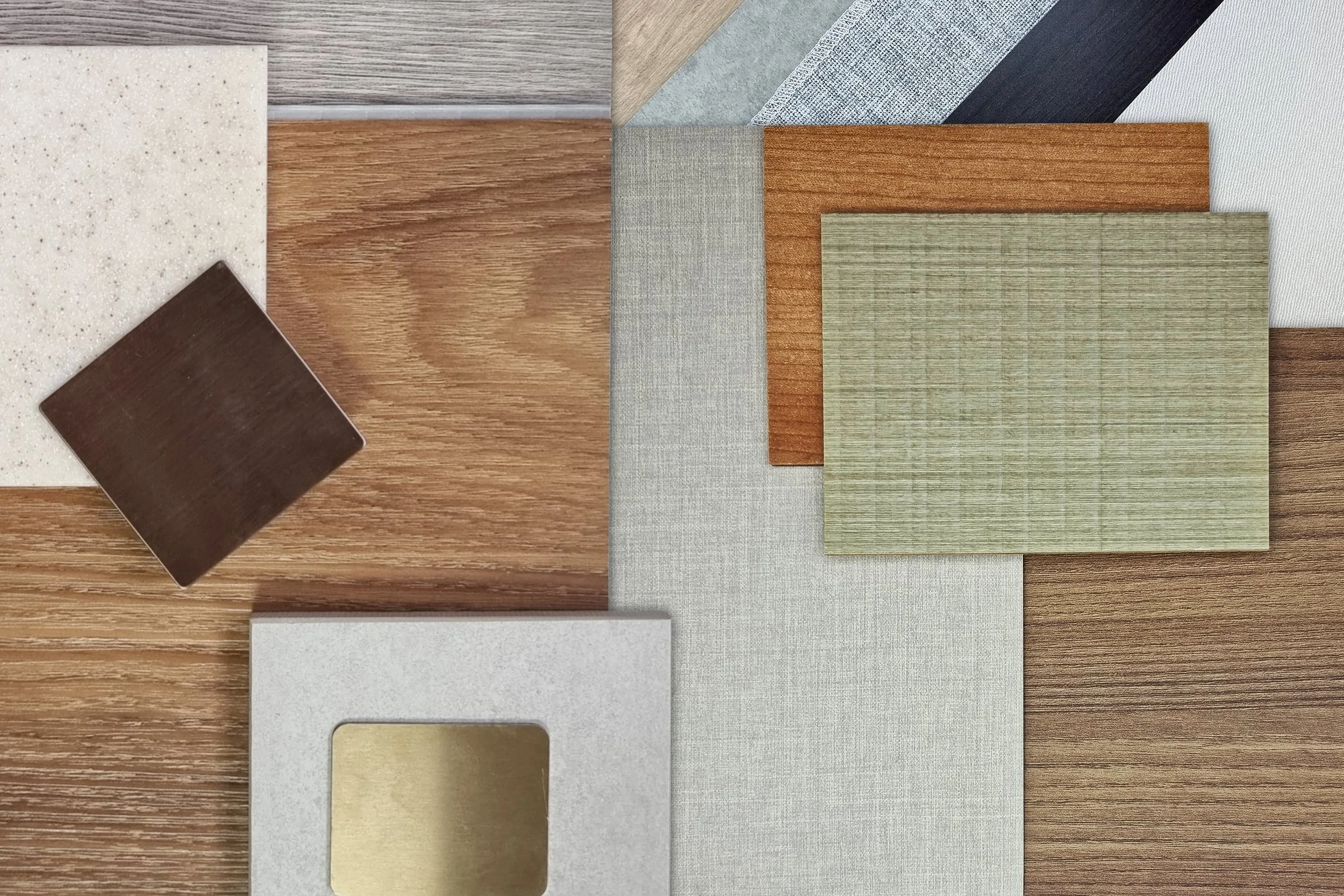 Arrangement of various sample materials including wood, fabric, laminate, and tile.
