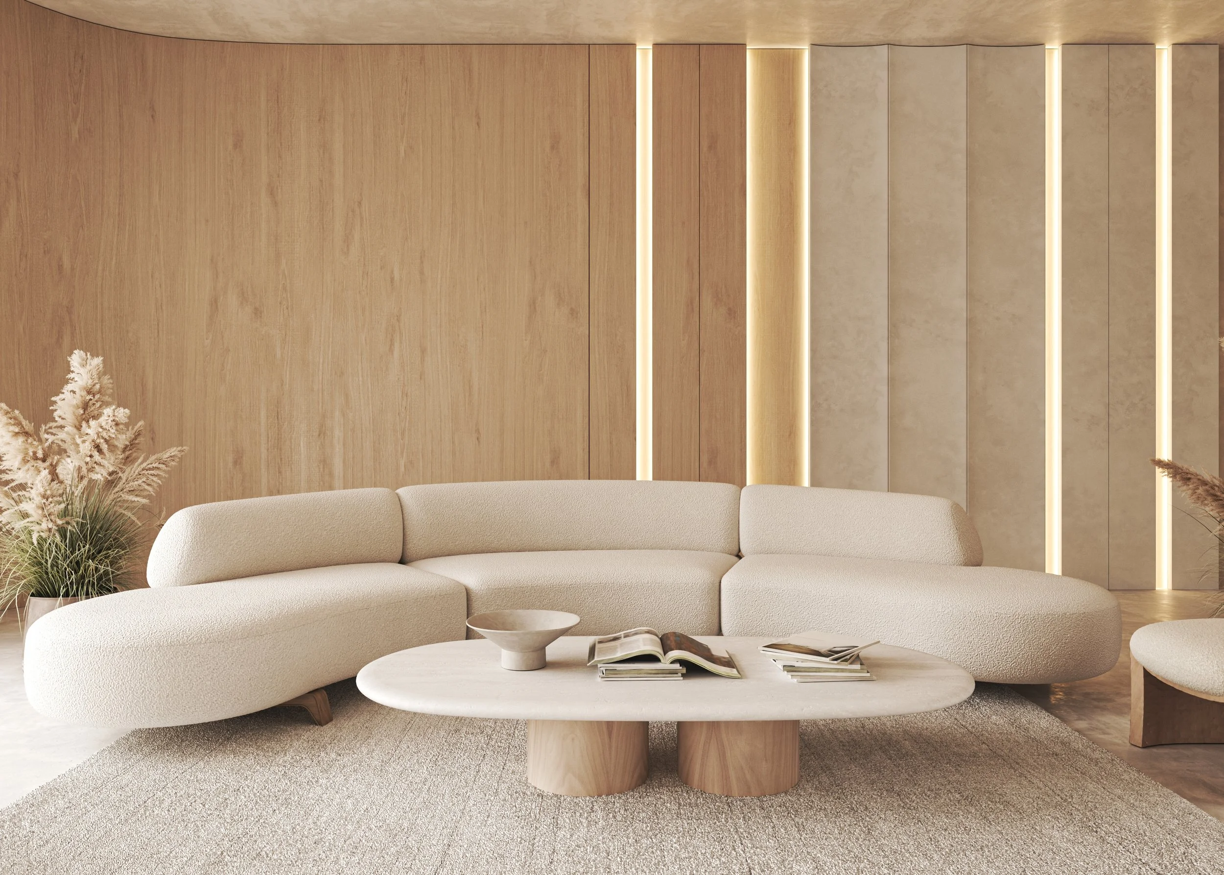 Modern living room with a beige rounded sectional sofa, a white marble coffee table with open books, and a textured beige wall with warm vertical lighting, decorated with pampas grass plants.