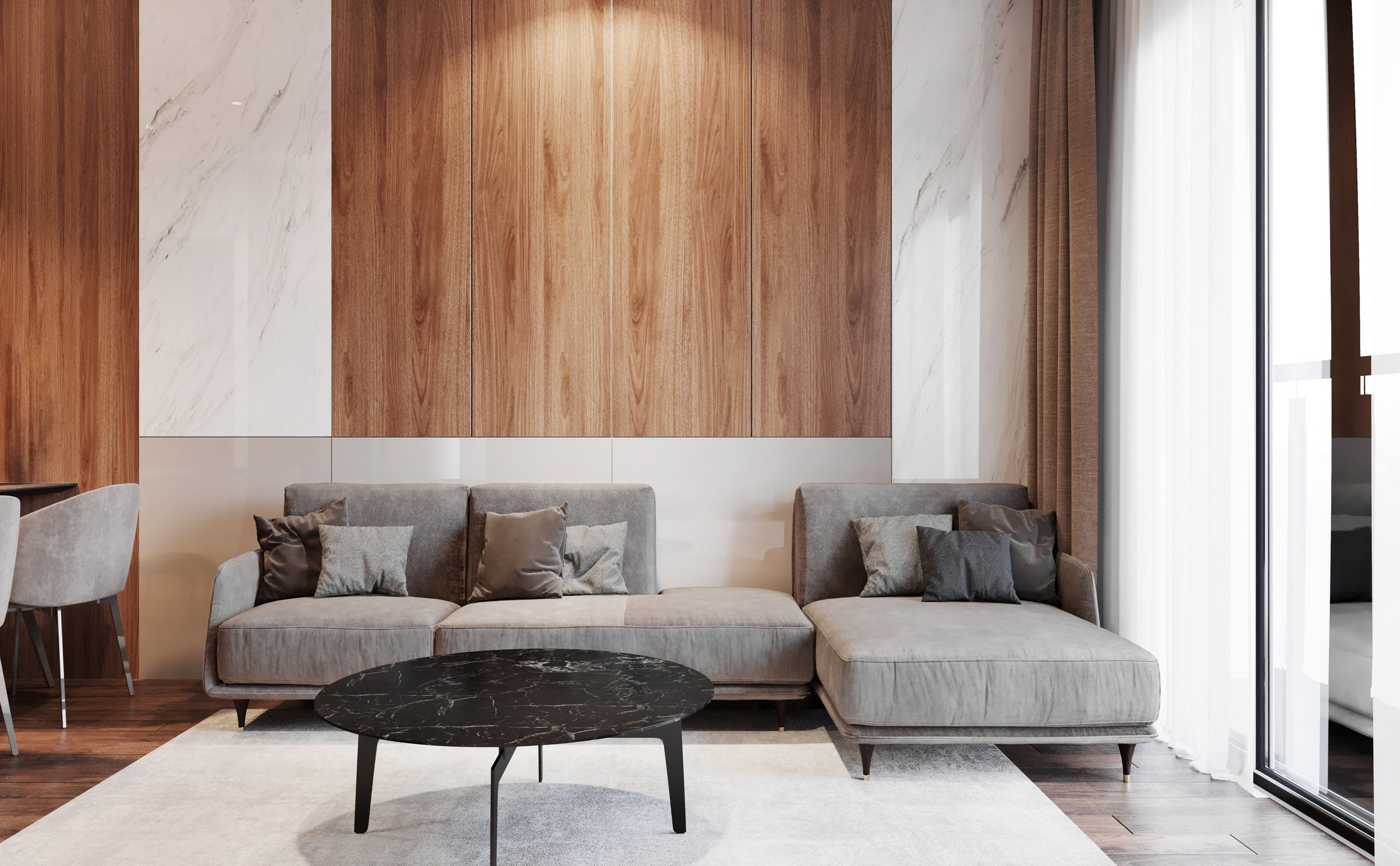 Modern living room with a grey sectional sofa, black marble coffee table, and wood-paneled wall with white marble accents, beside a large window with sheer white curtains.