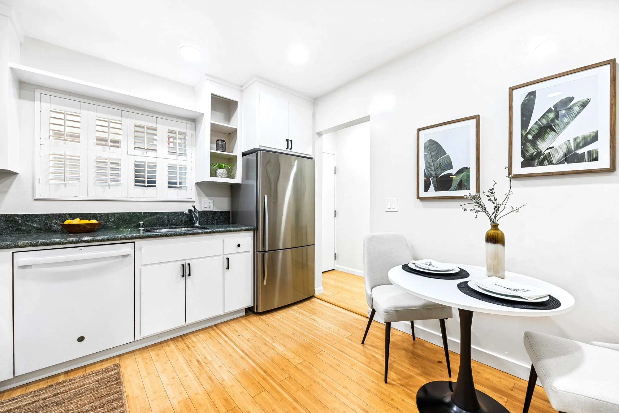 Modern kitchen with hard wood floors and table and chairs
